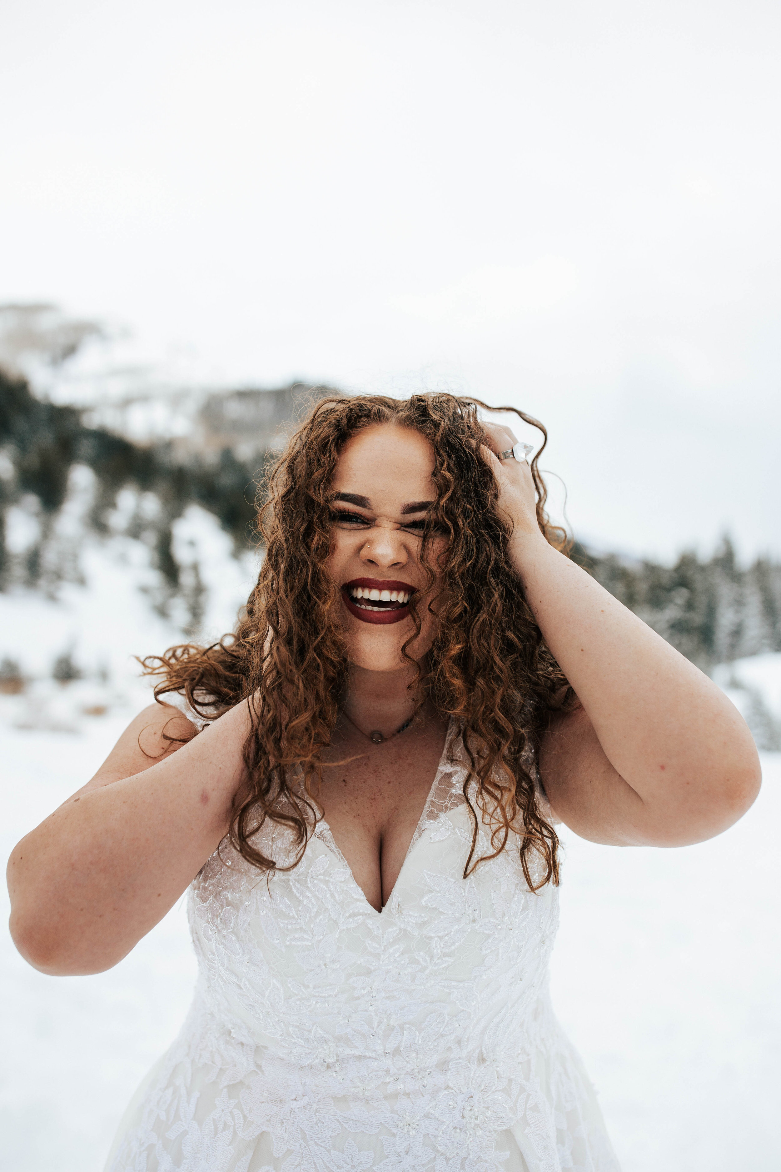 Snowy mountain winter bridals long curly hair big eyes blue florals wedding dress bride #utahphotographer #weddingphotographer #bride #bridals wedding dress