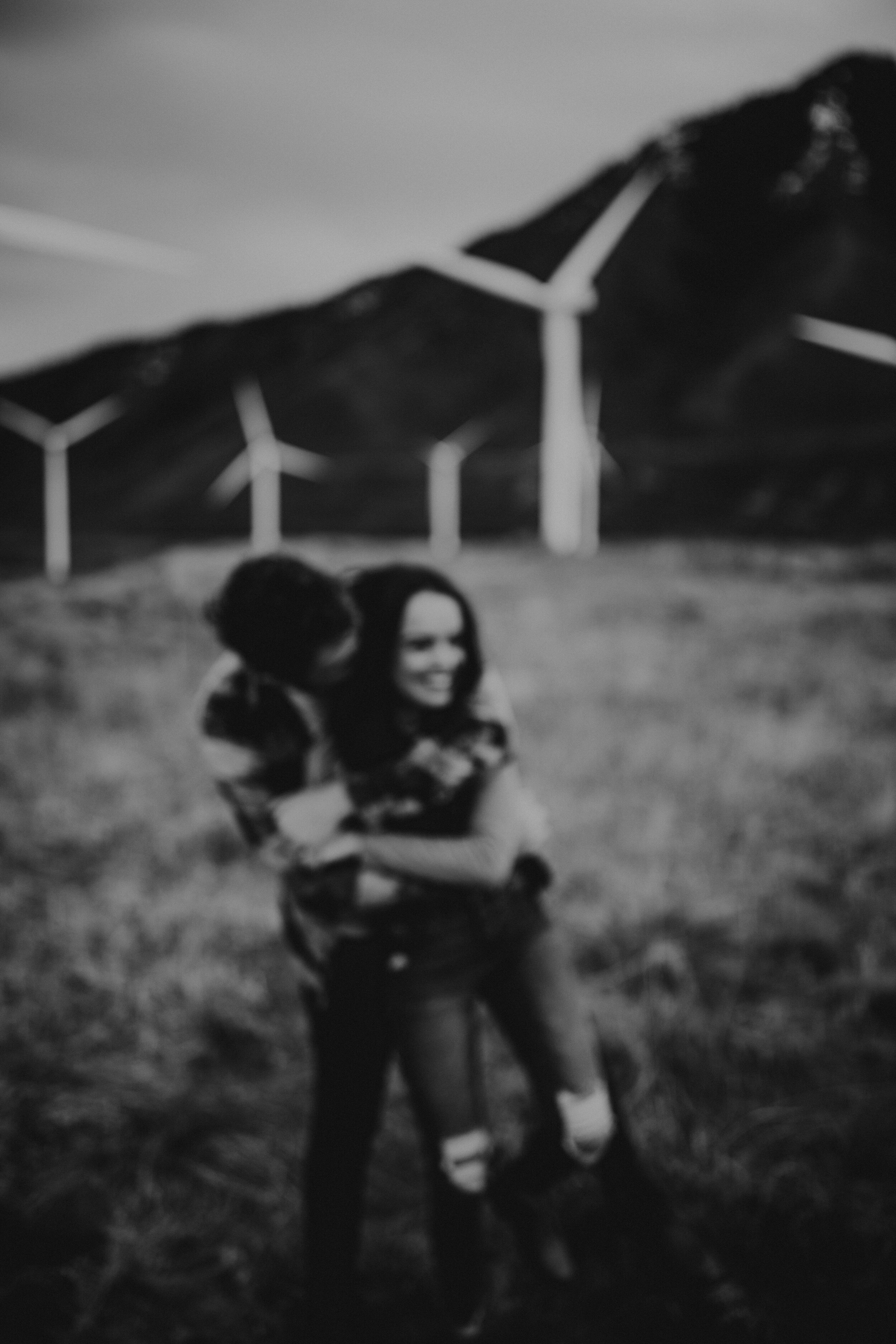 Black and white couples session windmills windy moody evening shoot. Engagement session. Utah wedding photographer. #utahphotographer #oregonphotographer #washingtonphotographer #coupleshoot
