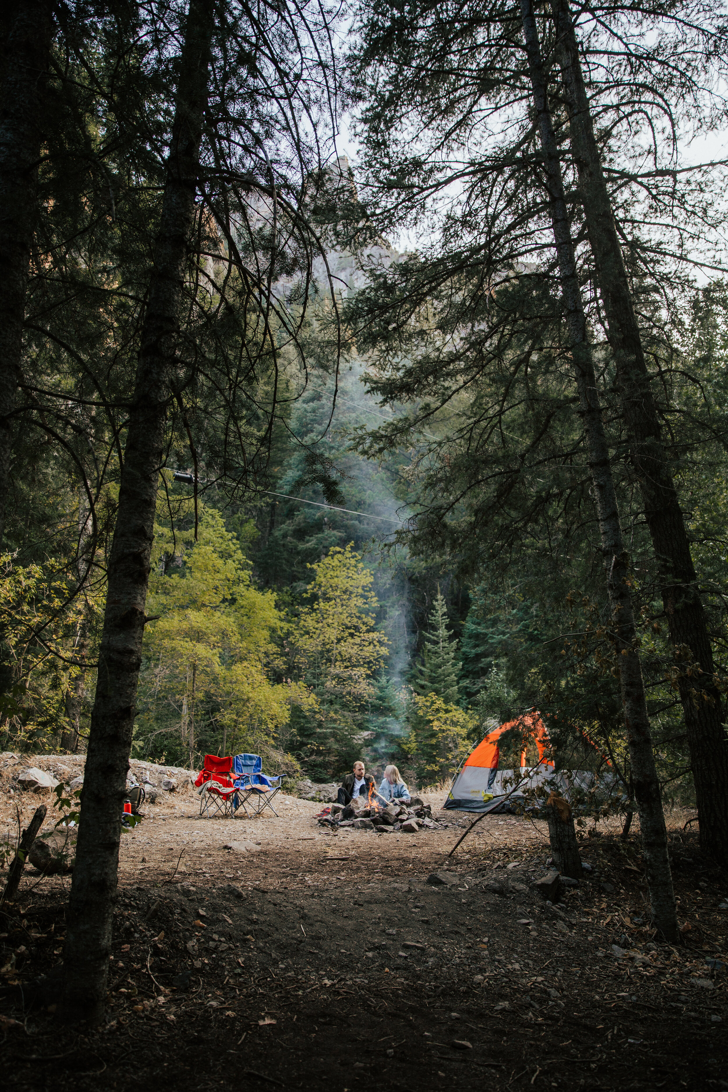 Adventure couples shoot camping in the mountains forest engagements Utah engagement photographer Utah couples photographer Oregon photographer PNW campfire tent