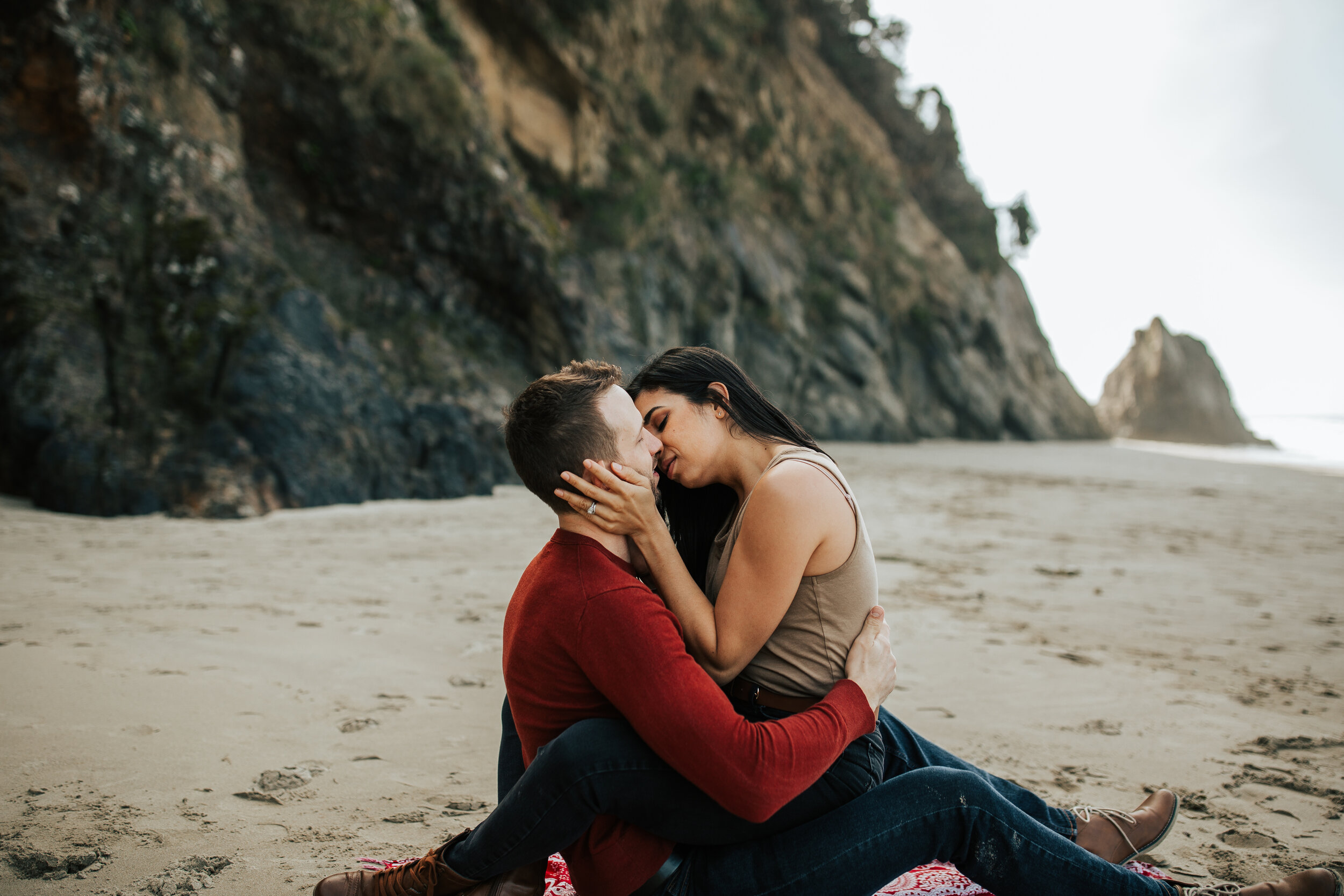 Oregon coast engagement session kissing cute adventurous couples shoot at Hug Point in the PNW beach engagements #oregonphotographer #engagements 