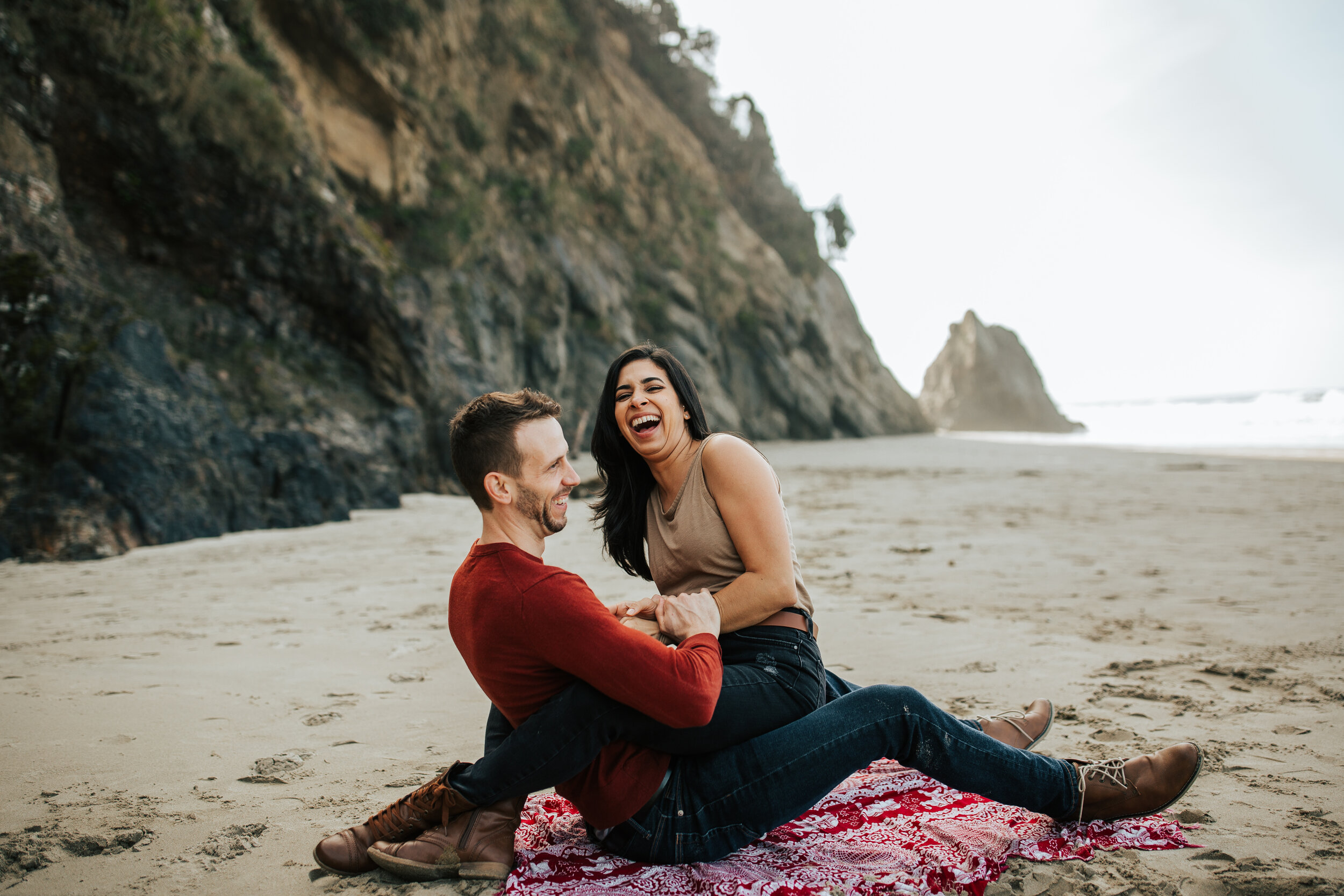 Oregon coast engagement session laughing cute adventurous couples shoot at Hug Point in the PNW beach engagements #oregonphotographer #engagements 
