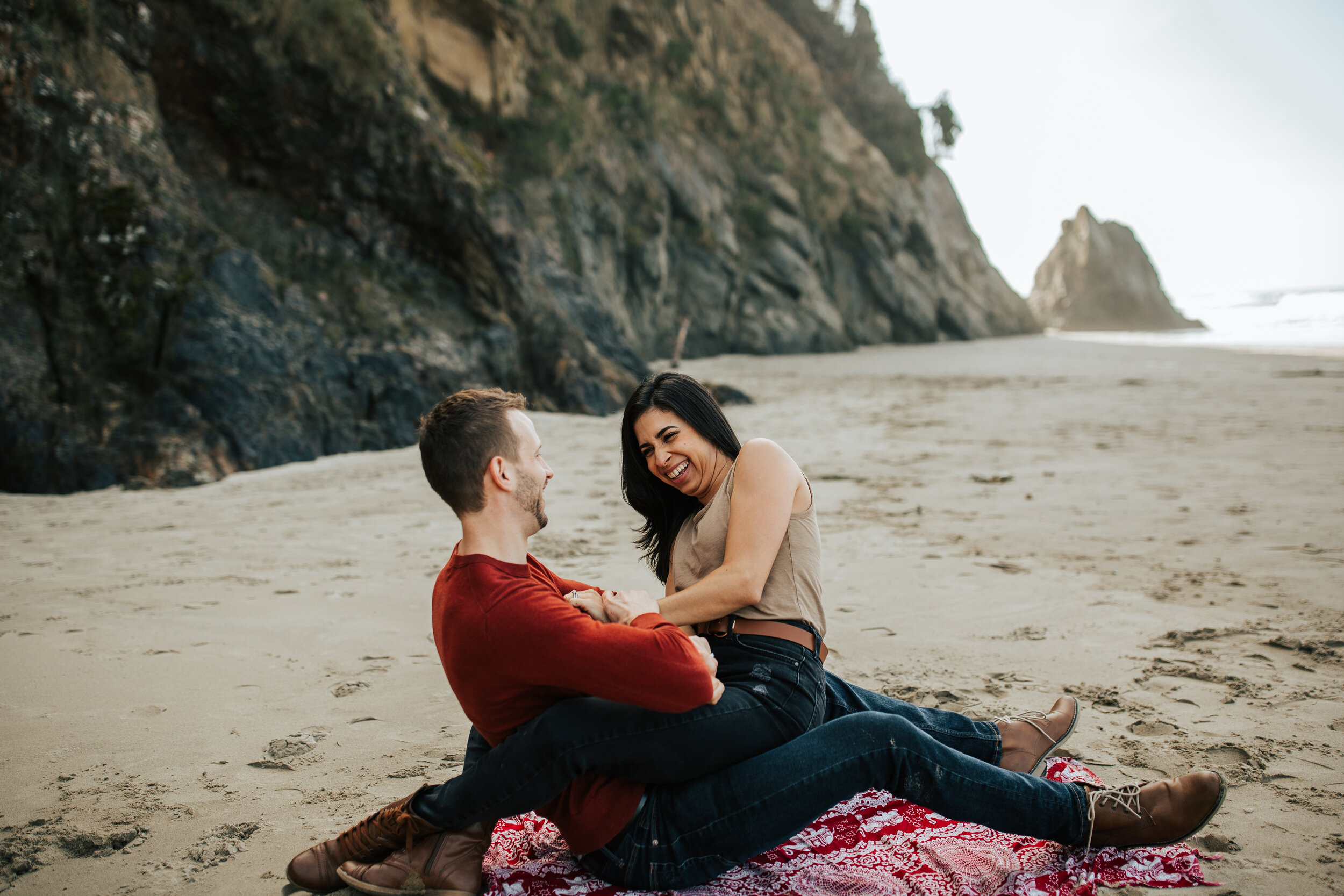 Oregon coast engagement session tickle fight cute adventurous couples shoot at Hug Point in the PNW beach engagements #oregonphotographer #engagements 