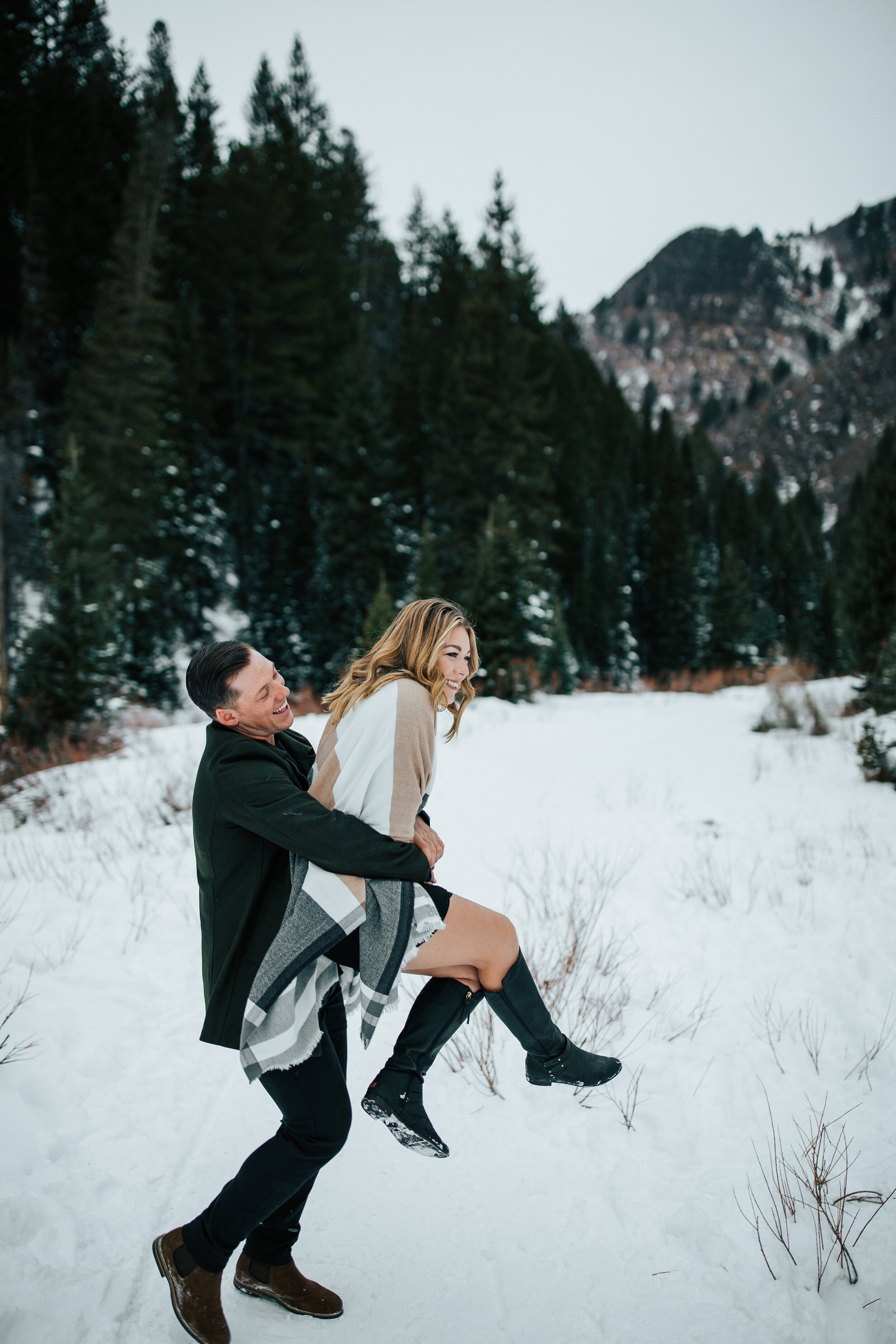 Winter engagement session in Utah mountains Big Cottonwood Canyon engagement shoot #utahphotographer #winterengagements playful couple