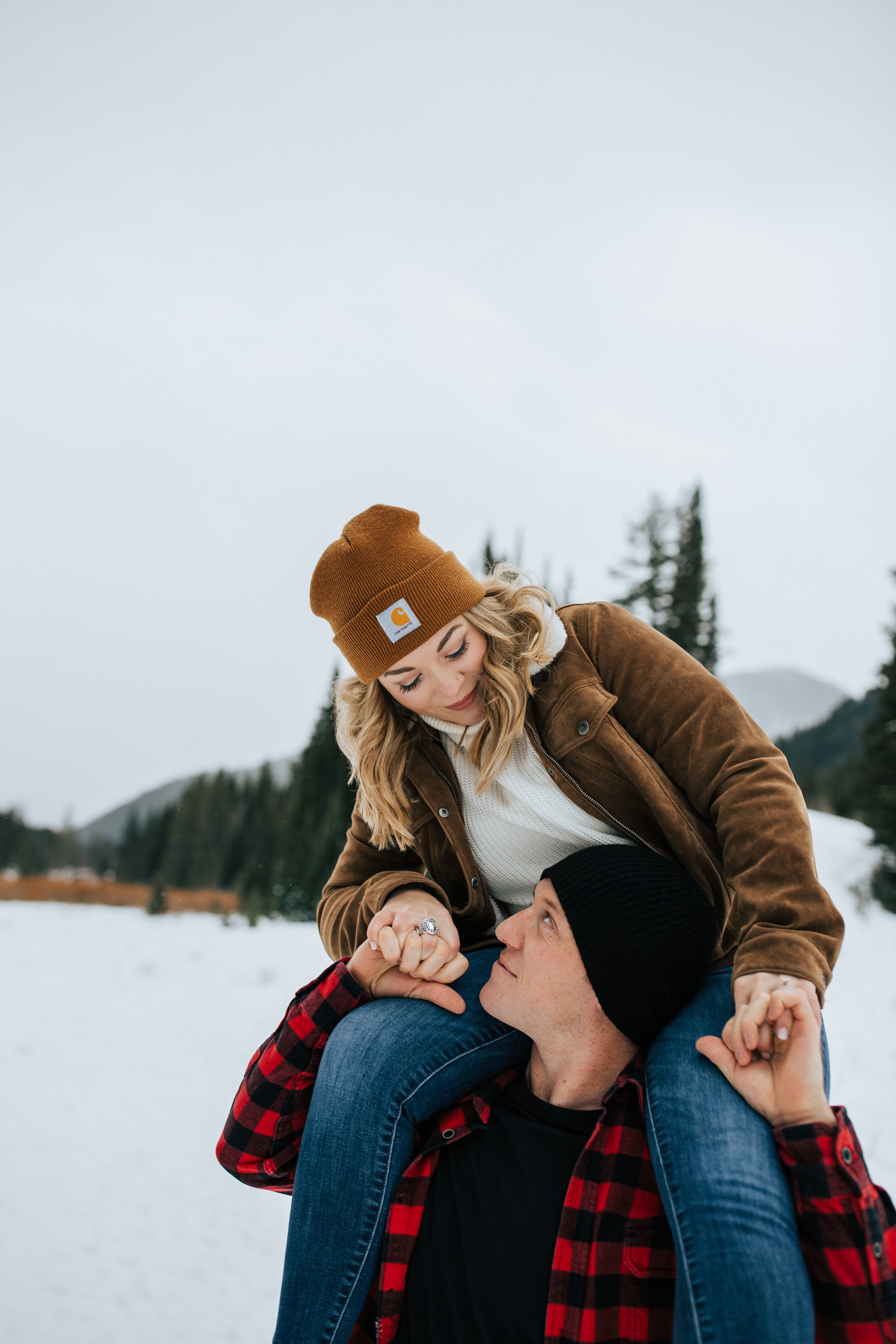 Winter engagement session in Utah mountains Big Cottonwood Canyon engagement shoot #utahphotographer #winterengagements Utah winter couple photoshoot girl on shoulders