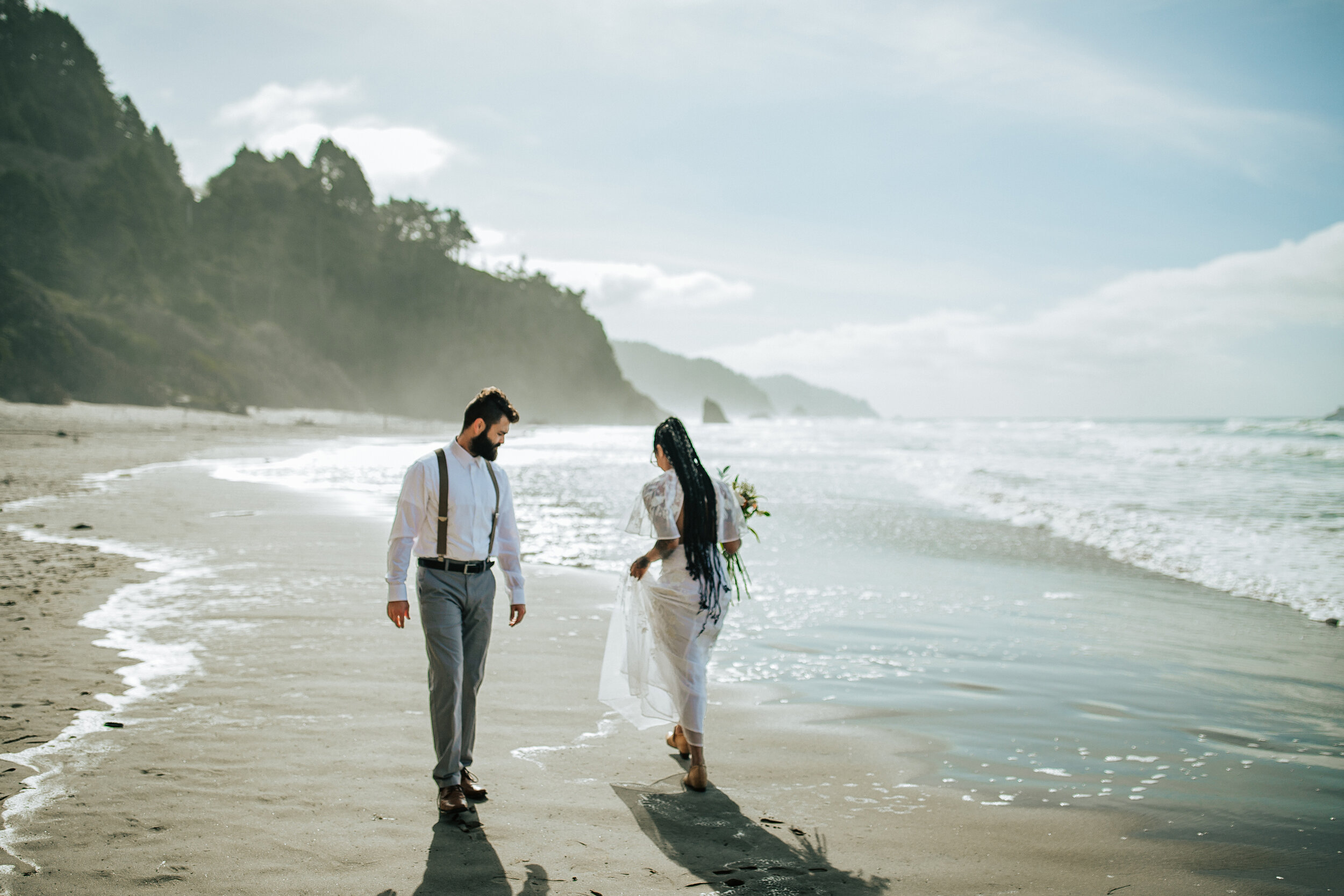  A beautiful couple walk by each other on the Oregon Coast in a stunningly bright and airy elopement photo shoot by professional photographer Emily Jenkins Photography. Couple goals elopement photo shoot goals elopement inspiration elopement photo sh