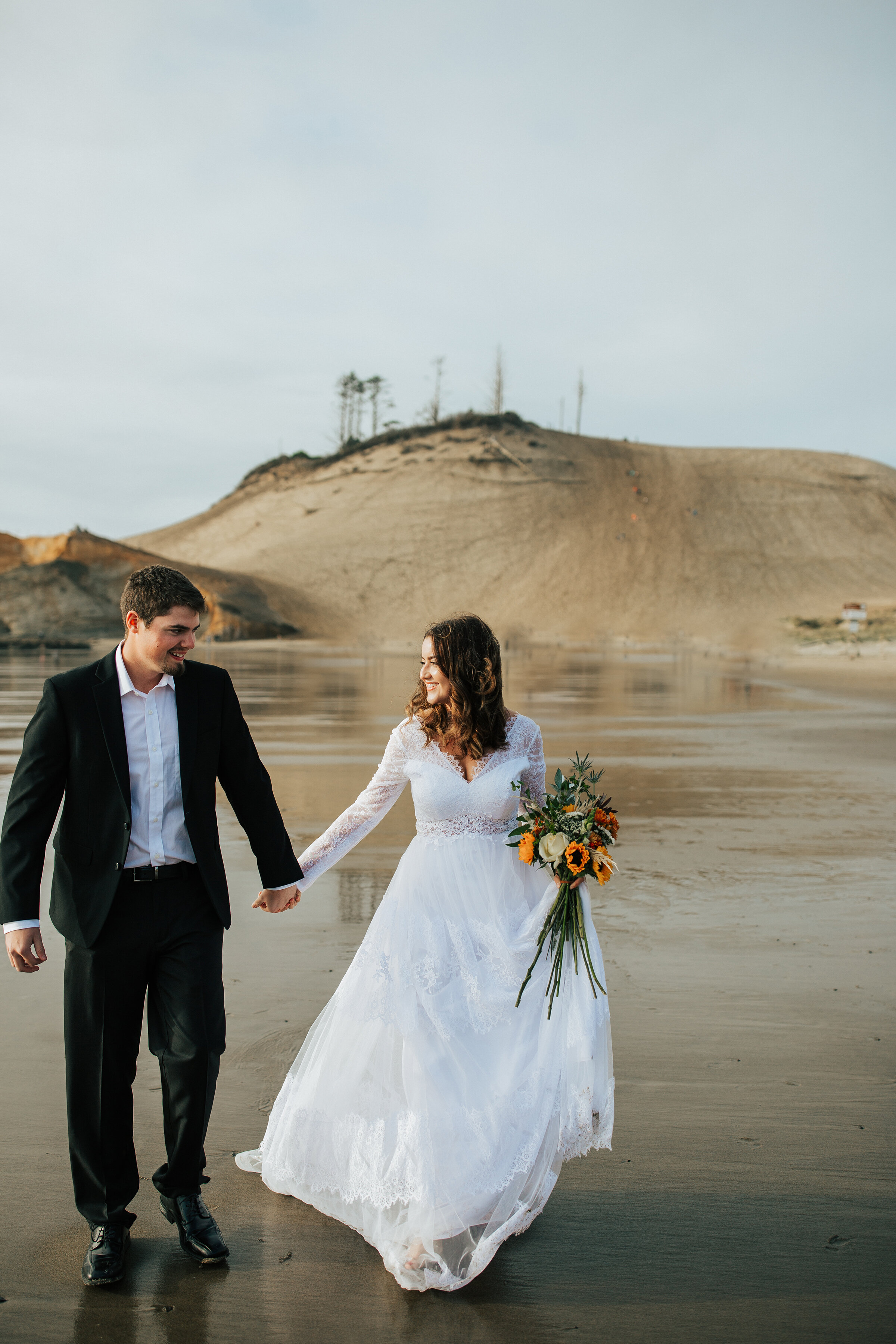  A stunning couple walk along the beach of the Oregon Coast in a beautiful elopement photo shoot by Emily Jenkins Photography. Wedding inspiration elopement inspiration ideas and goals elopement photographer professional Oregon photographer couple po