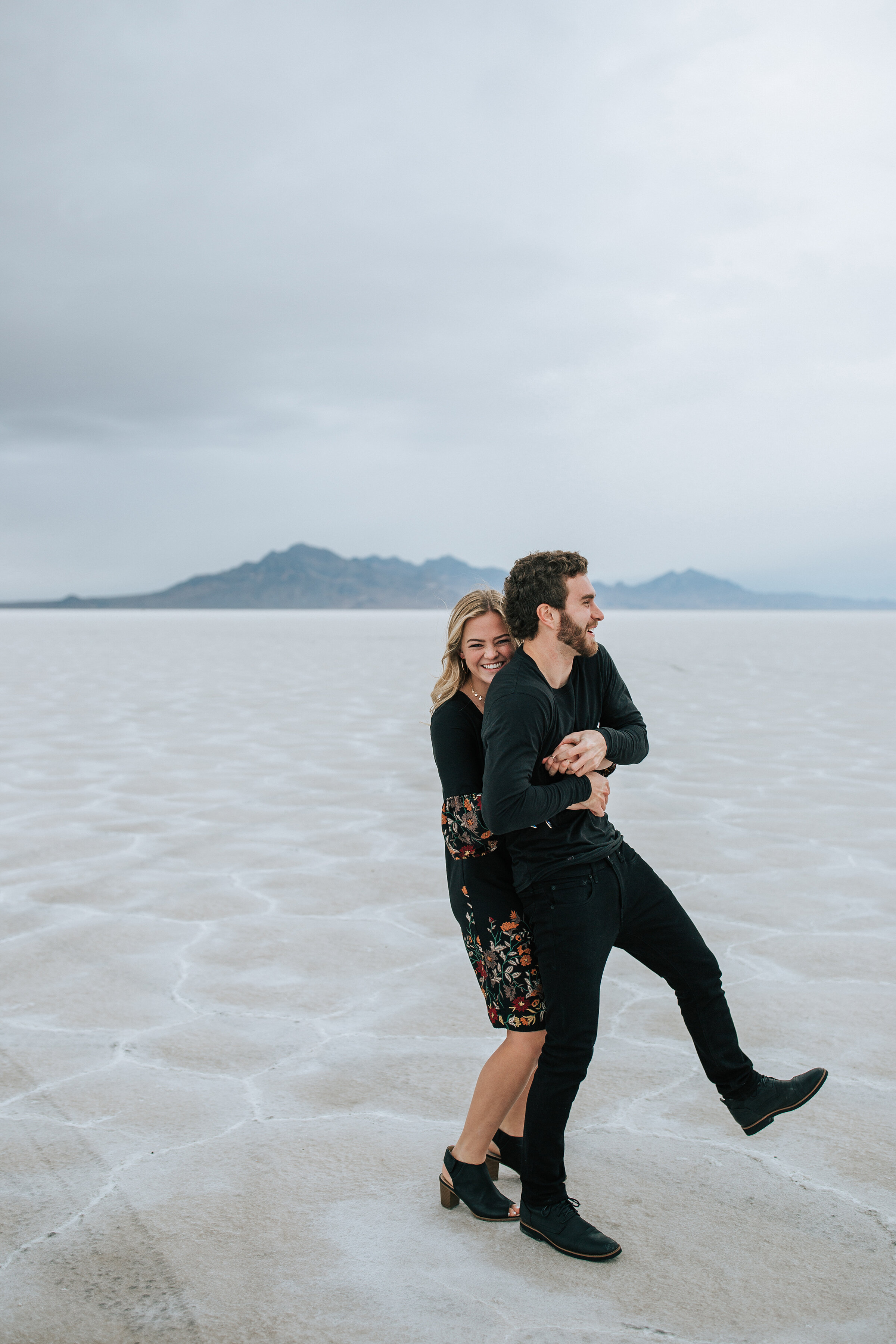  A playful couple hug in a stunning engagement session in Utah by professional couple photographer Emily Jenkins Photography. Couple goals playful couple pose inspiration ideas and goals client attire inspiration for men and women semi formal client 