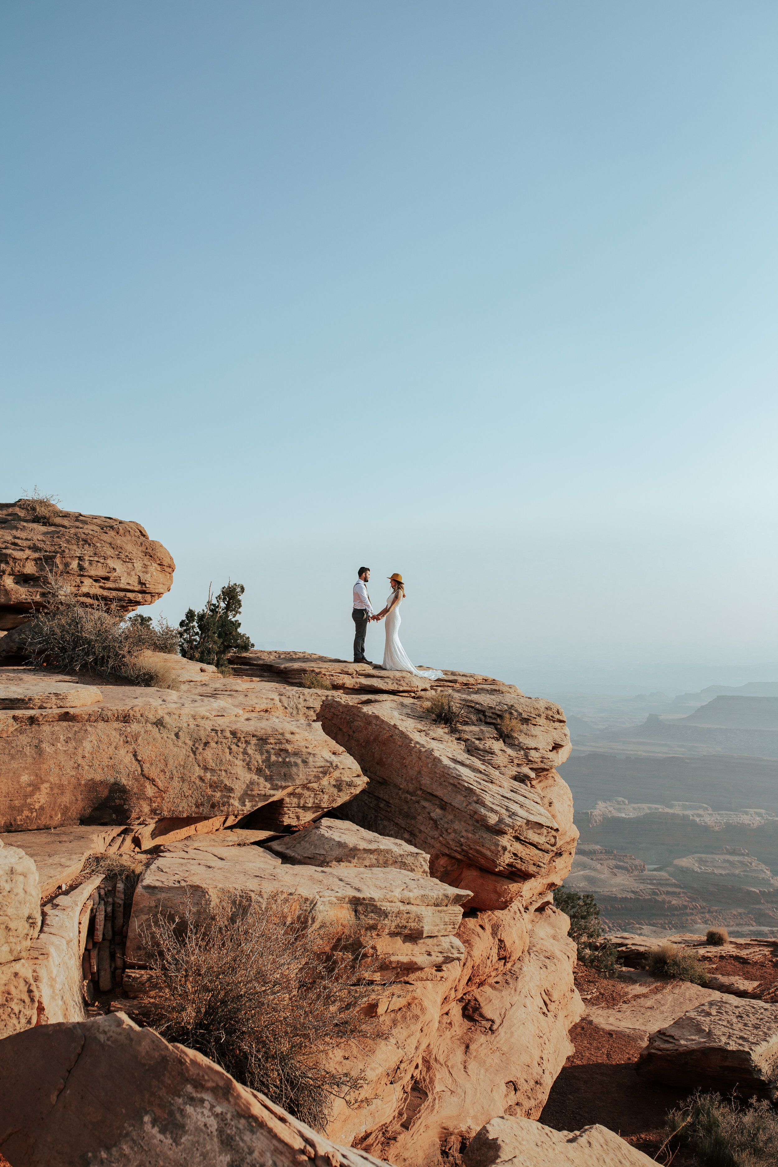 Vow Renewal Photographer Emily Jenkins captures a stunning Utah red rock desert portrait of a couple holding hands with a blue sky. Red rock couple pic wedding photographer professional couple photographer vow renewal ideas vow renewal dream locatio