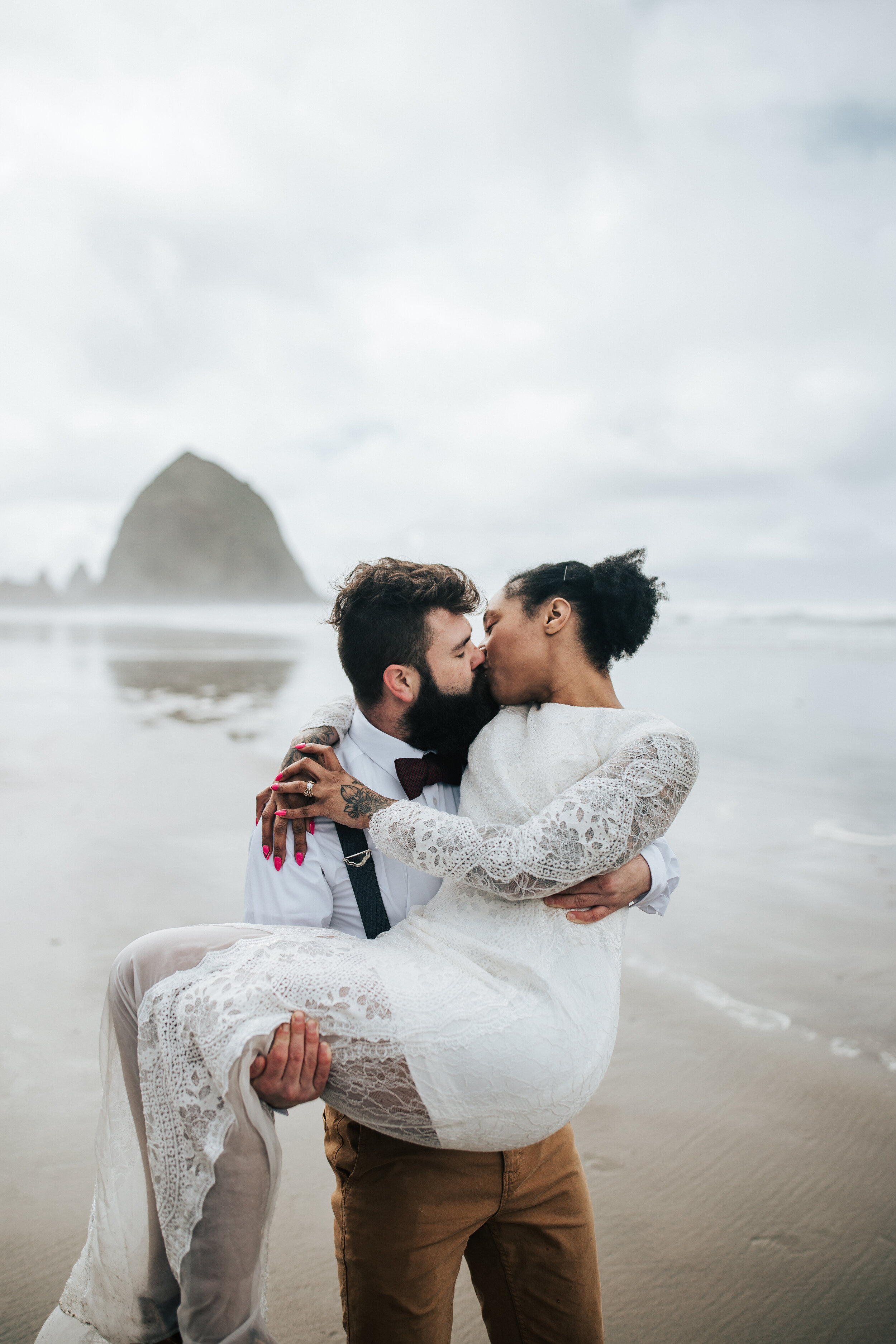  Photographer Emily Jenkins captures the husband holding his wife in his arms kissing her at Pacific City, Oregon. Oregon each travel renewal travel photographer wedding redo creative anniversary ideas vow renewal dress ideas  pacific cape #vowrenewa