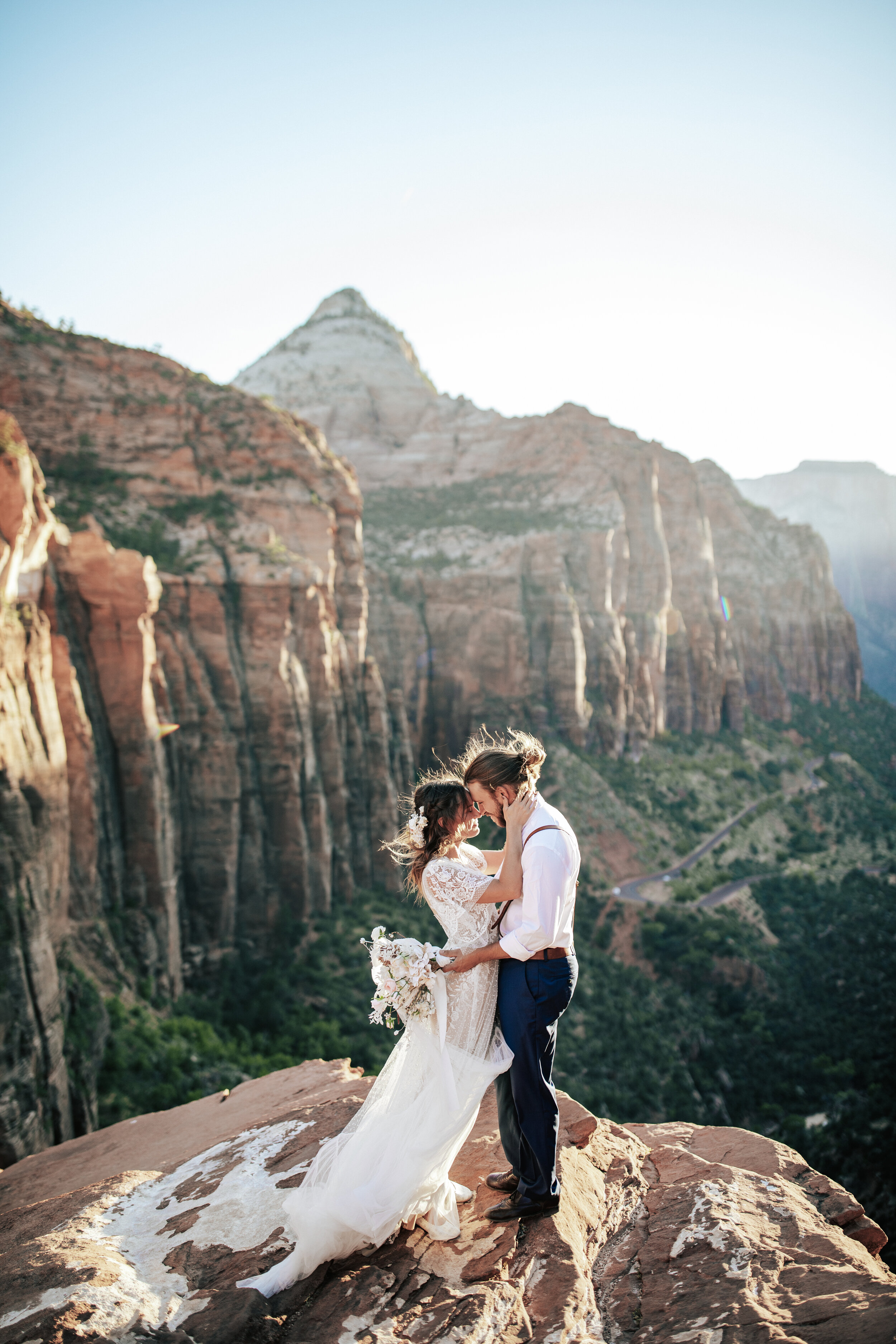  A glowing couple hold each other close in a bright and airy elopement styled photo shoot in Zion National Park by professional elopement photographer Emily Jenkins Photography.  Outdoor photo shoot inspiration ideas and goals couple goals wedding go