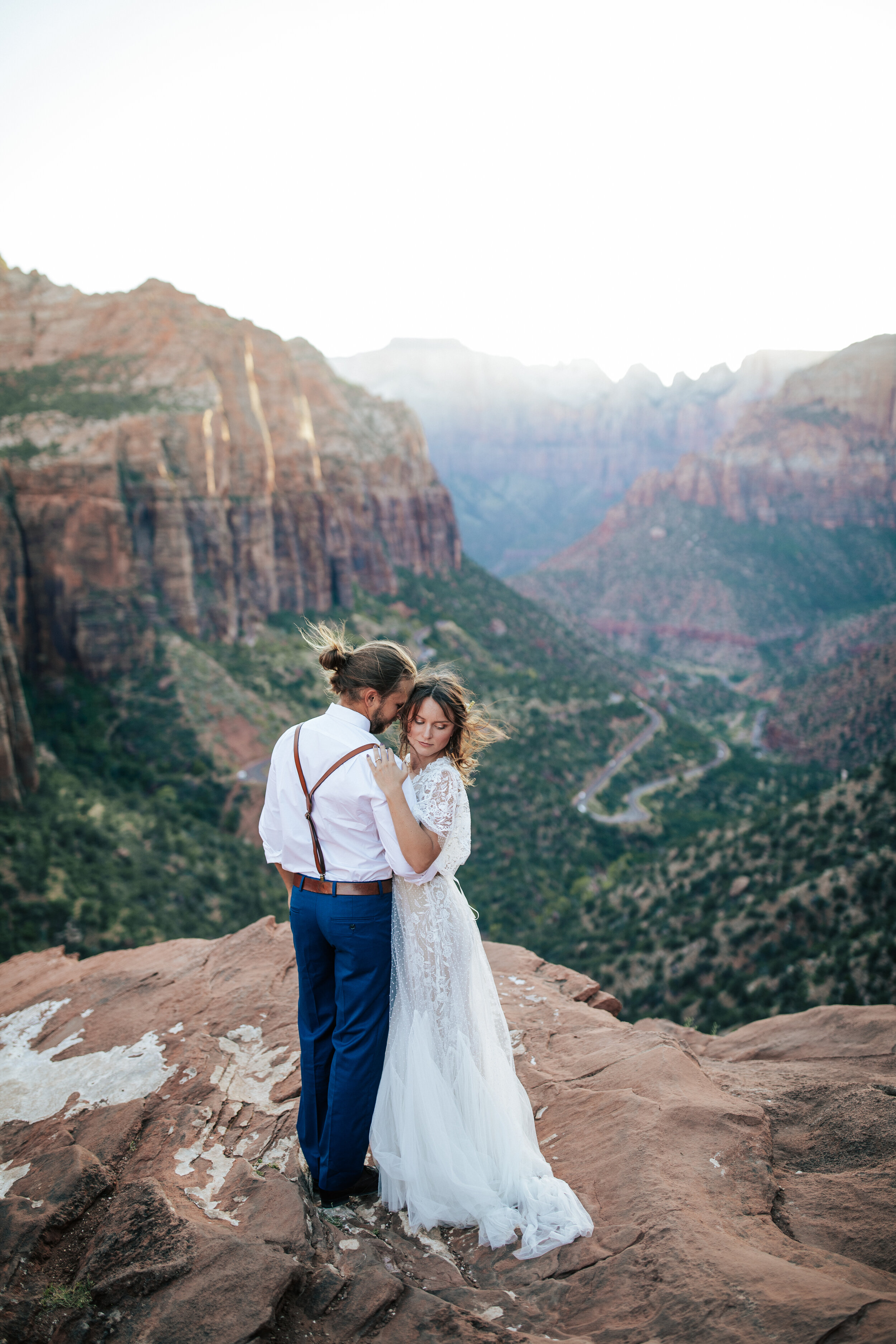  A beautiful couple dance together on the cliffs of Zion National Park in an elopement styled photo shoot by Emily Jenkins Photography. Wedding picture location inspiration ideas and goals couple goals wedding goals bridal wedding dress inspiration i