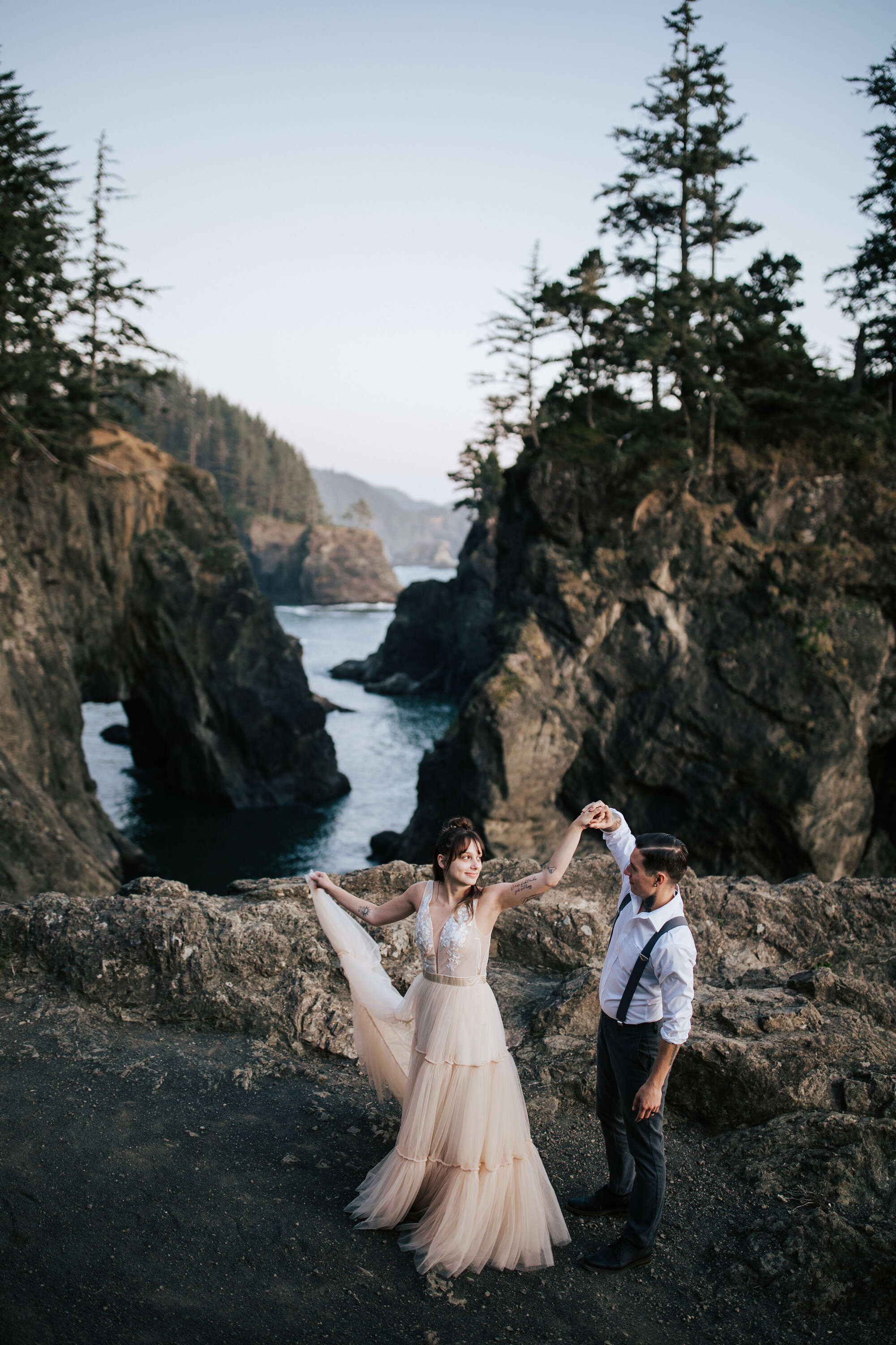  Oregon Coast elopement photographer Emily Jenkins Photography captures a groom spining his bride around in a twirl during their intimate beach wedding portraits. beach wedding portraits travel photographer destination photographer Oregon #emilyjenki
