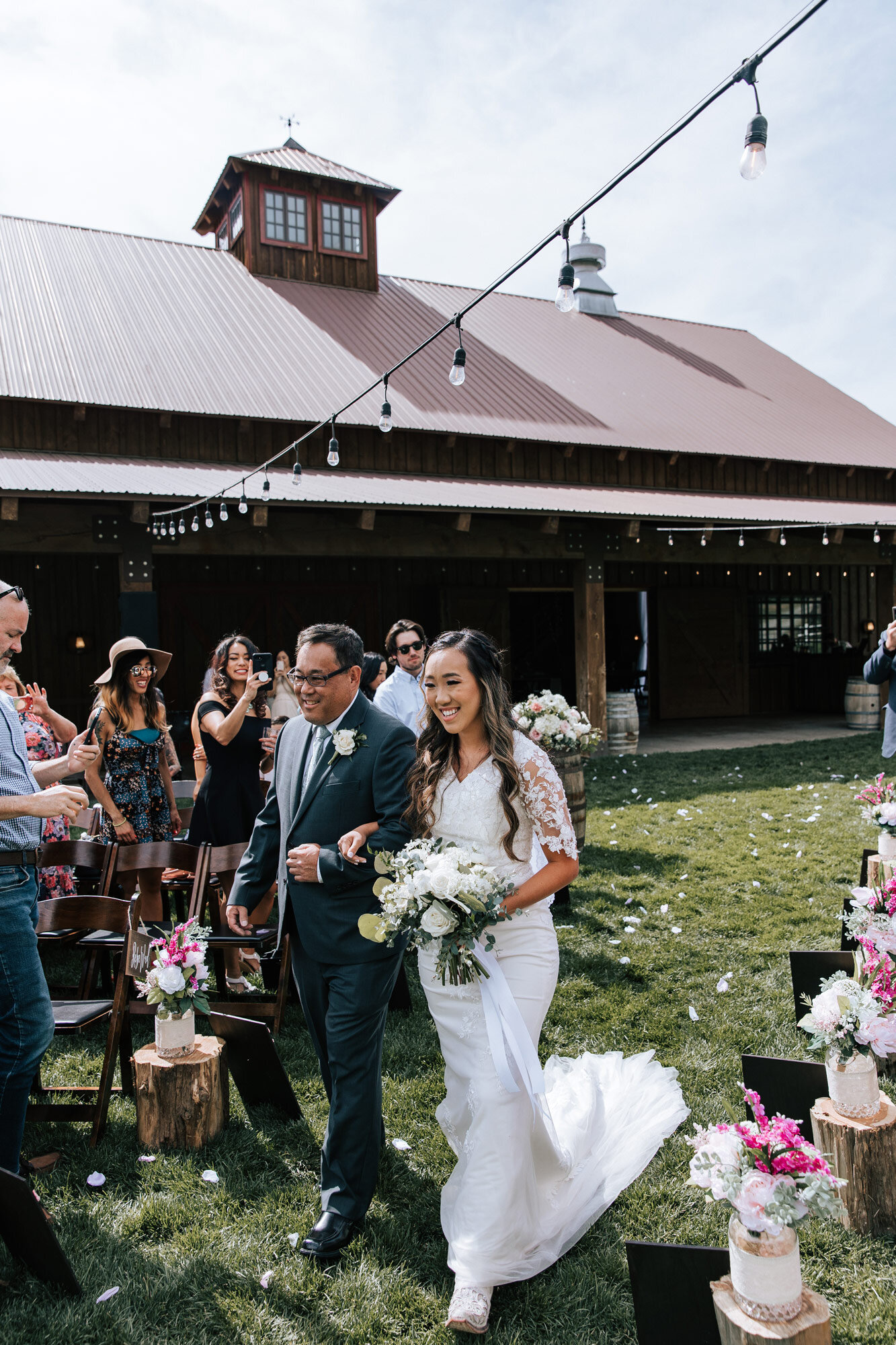  Bride and her father walk down the aisle arm in arm in a beautiful farm wedding venue in Mapleton, Utah was taken by Emily Jenkins Photography. escorting the bride walk down the aisle Utah wedding venue #emilyjenkinsphotography #emilyjenkinsweddings