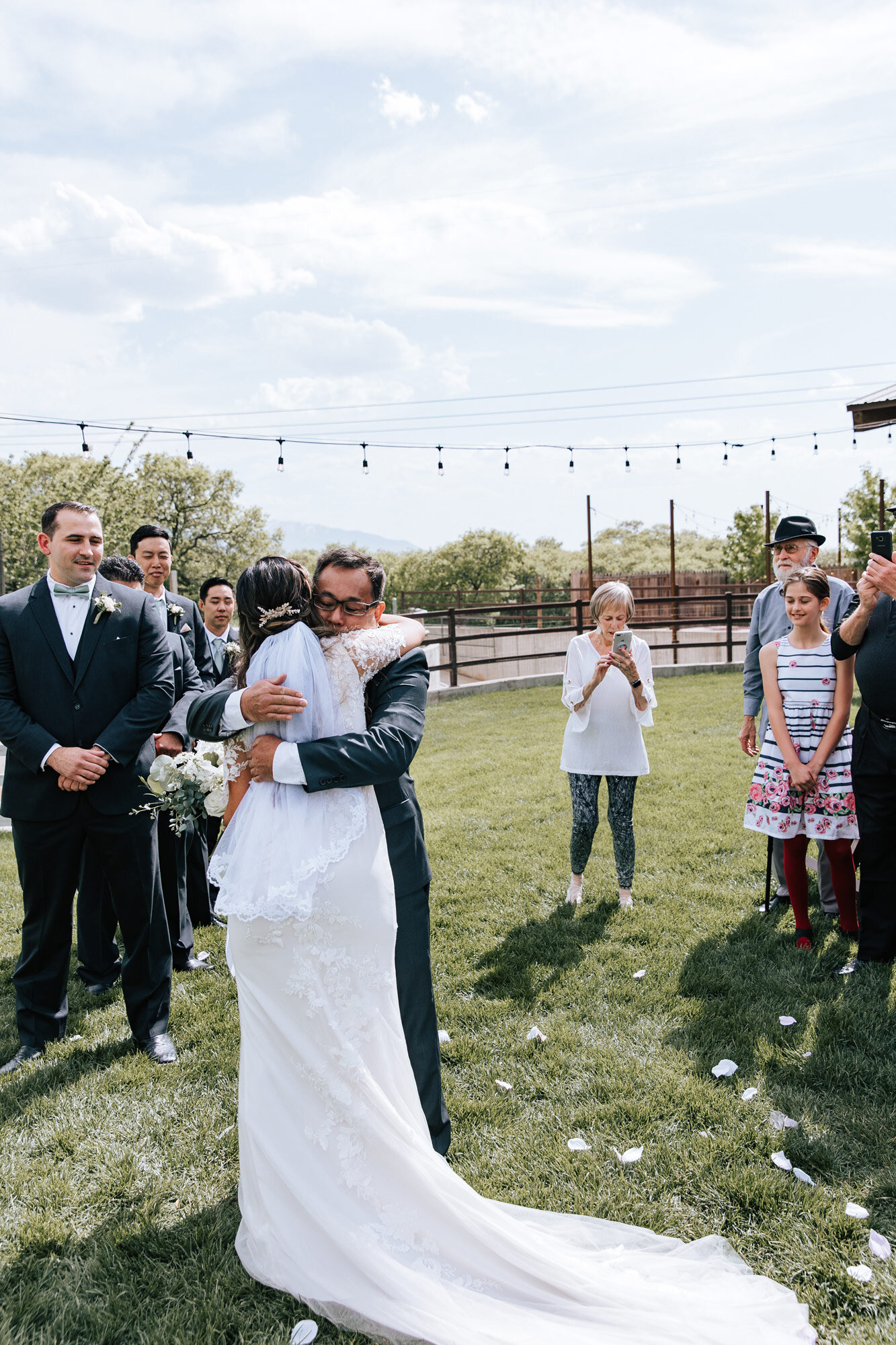  Emily Jenkins Photography captures a bride hugging her father at the end of the aisle at Quiet Meadow Farms a wedding venue in Utah. father hugs bride long classy wedding gown  farm wedding #emilyjenkinsphotography #emilyjenkinsweddings #utahwedding