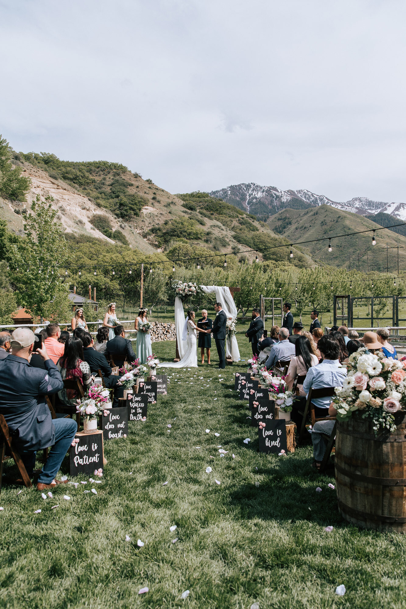  Beautiful couple at the altar of an outdoor wedding with guests in attendance in Mapleton, Utah mountains by Emily Jenkins Photography. outdoor altar photos wedding in progress Utah wedding venue #emilyjenkinsphotography #emilyjenkinsweddings #utahw