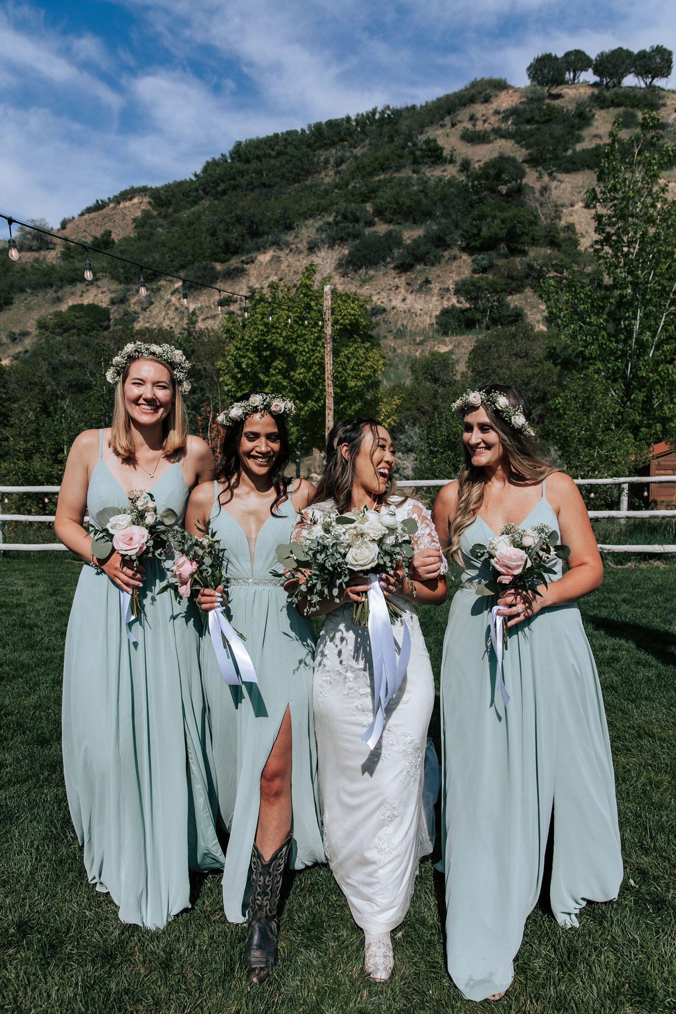  Emily Jenkins Photography laughs as she walks with her three bridesmaids in green dresses at a country wedding at Quiet Meadow Farms. green bridesmaid dresses floral crowns for bridesmaids #emilyjenkinsphotography #emilyjenkinsweddings #utahweddings
