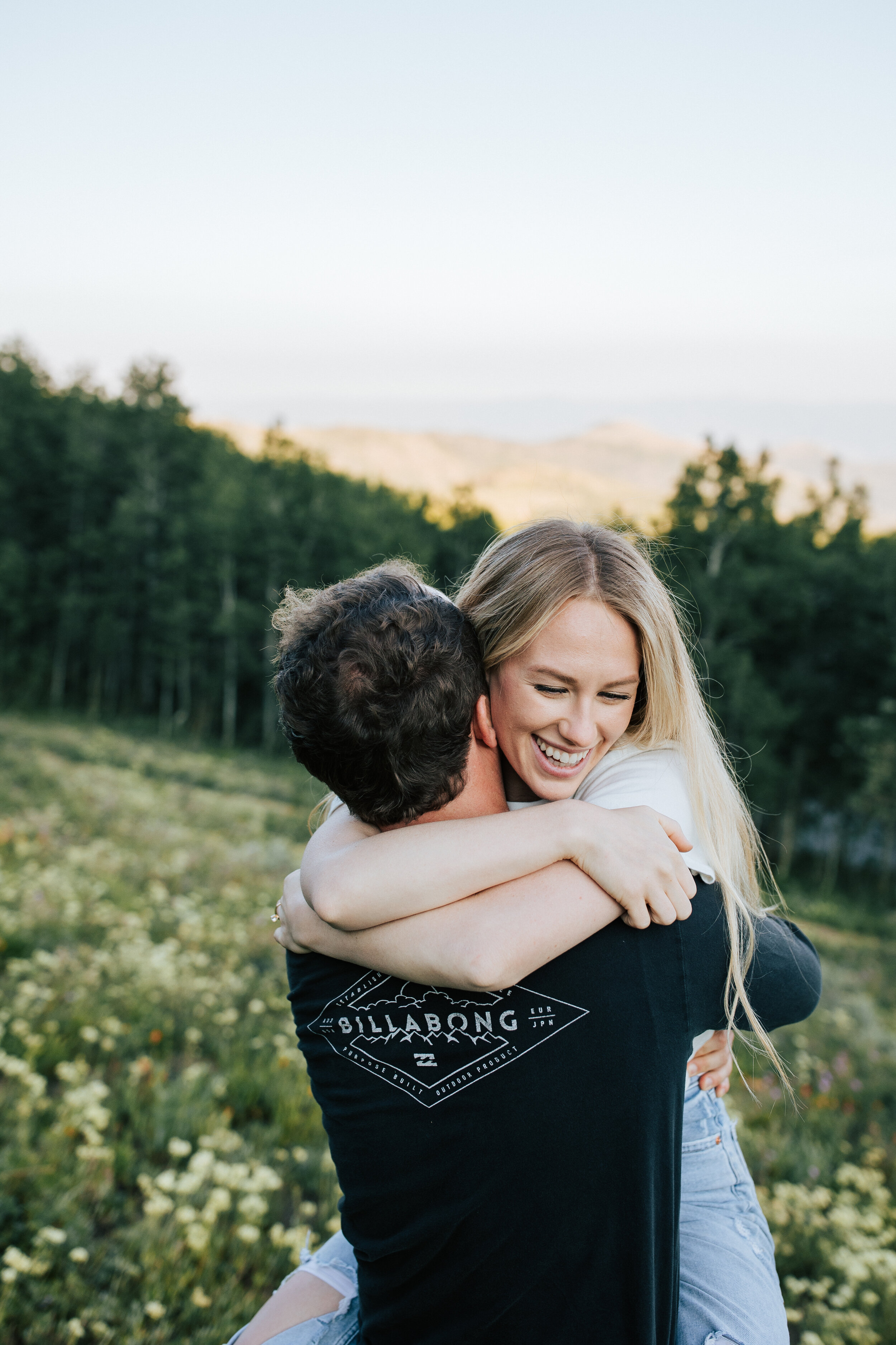  Engagement session in wildflowers in the mountains near Park City, Utah. Summertime engagement photos with mountain views. Engaged couple hug in the mountains. Outfit inspo. Engagement outfits. #engagementphotos #engagements #weddingphotographer #ph