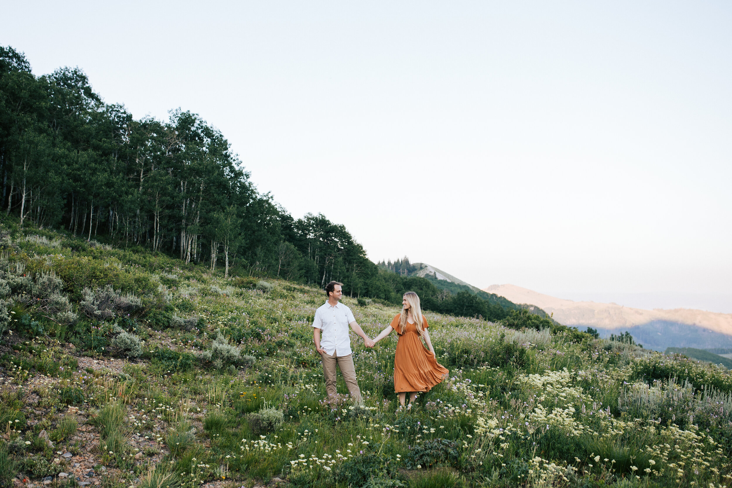  Engagement session in wildflowers in the mountains near Park City, Utah. Summertime engagement photos with mountain views. Engaged couple in the mountains. Outfit inspo. Engagement outfits. #engagementphotos #engagements #weddingphotographer #photog