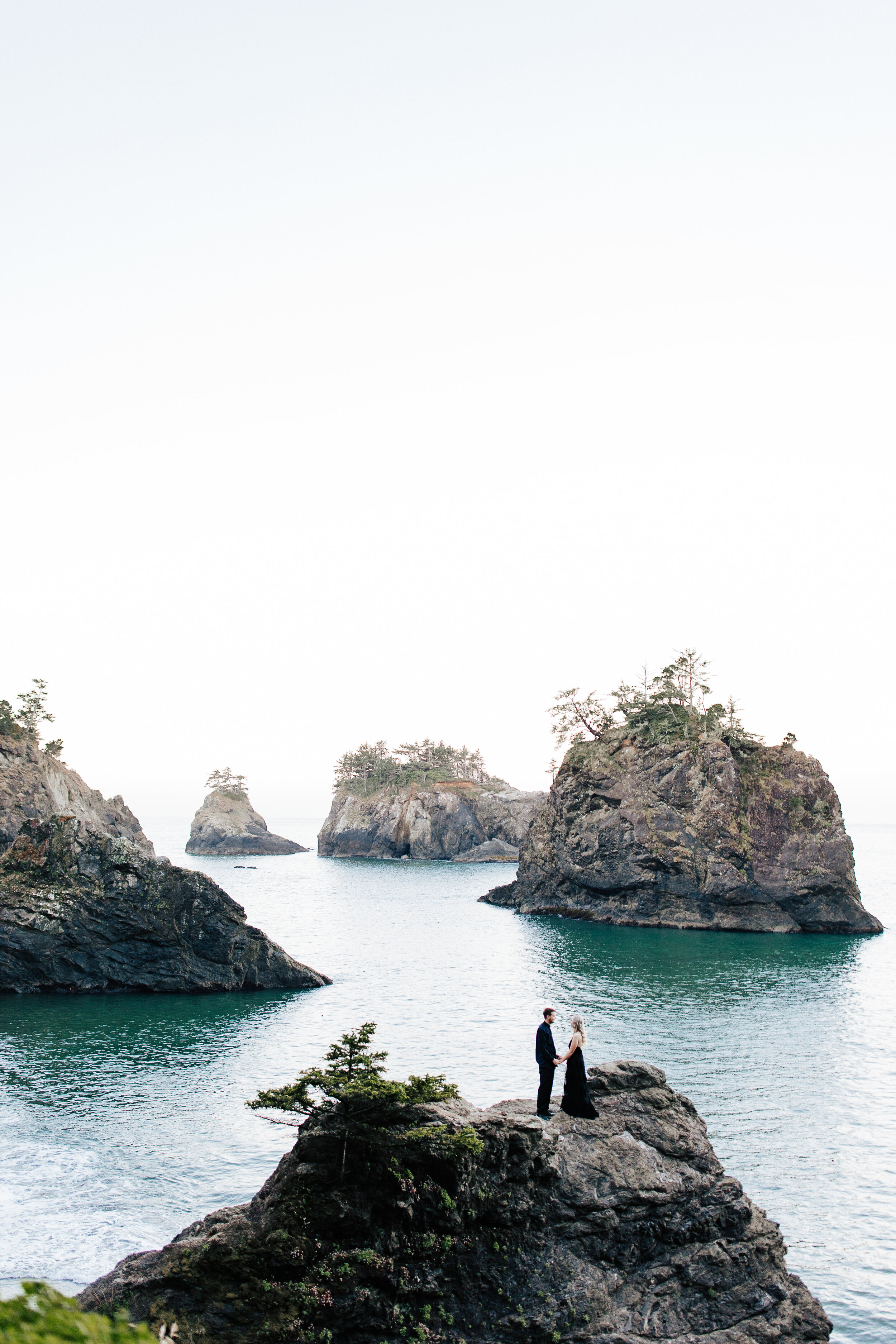 Samuel H Boardman Scenic Corridor southern Oregon coast elopement bride and groom saying their vows on a cliff on the Oregon coast with sea stacks and the ocean below black bridal gown couple in all black a groom walks with his new bride #oregonphot