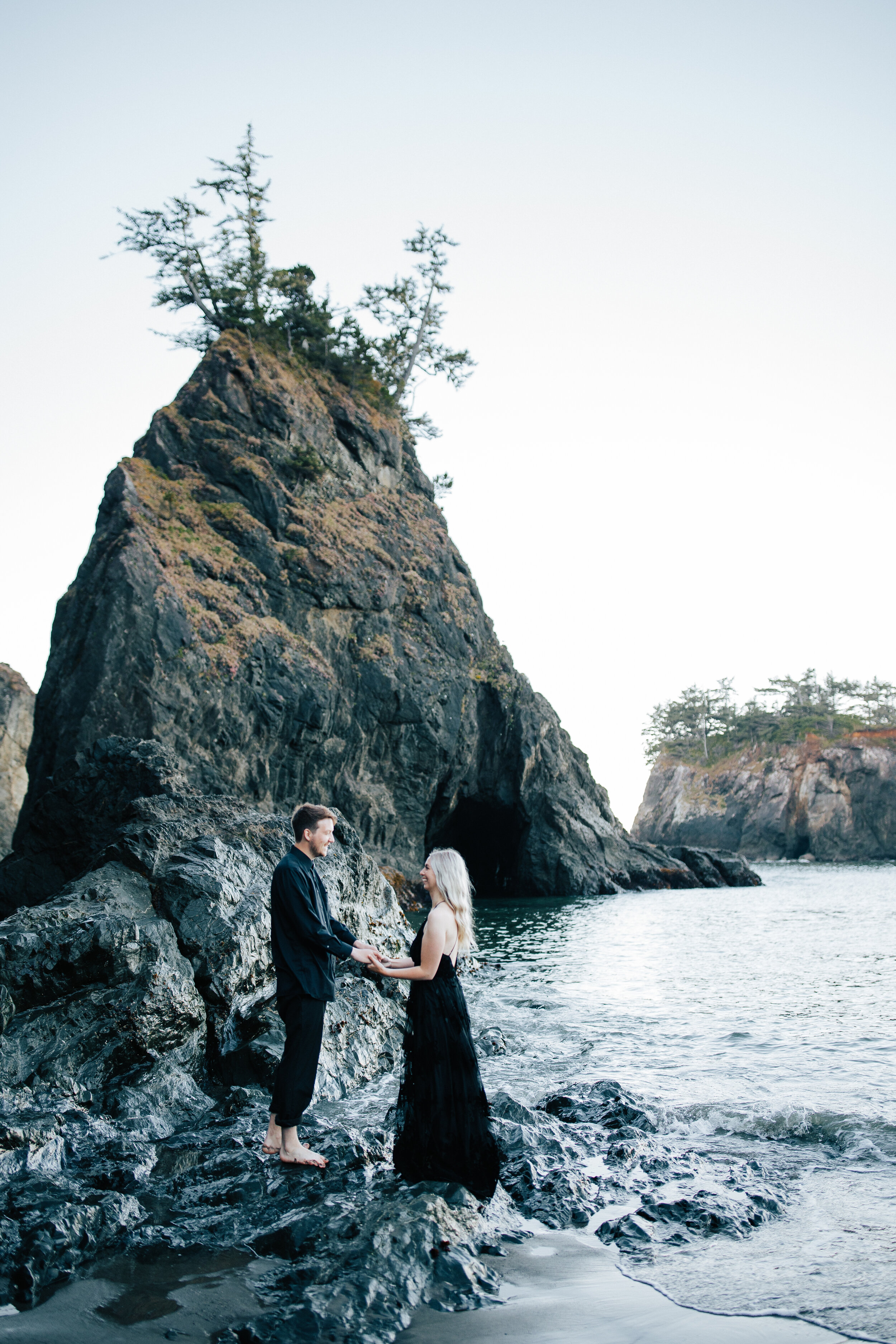  Samuel H Boardman Scenic Corridor southern Oregon coast elopement bride and groom saying their vows on the beach on the Oregon coast with sea stacks and the ocean below black bridal gown couple in all black a groom walks with his new bride #oregonph