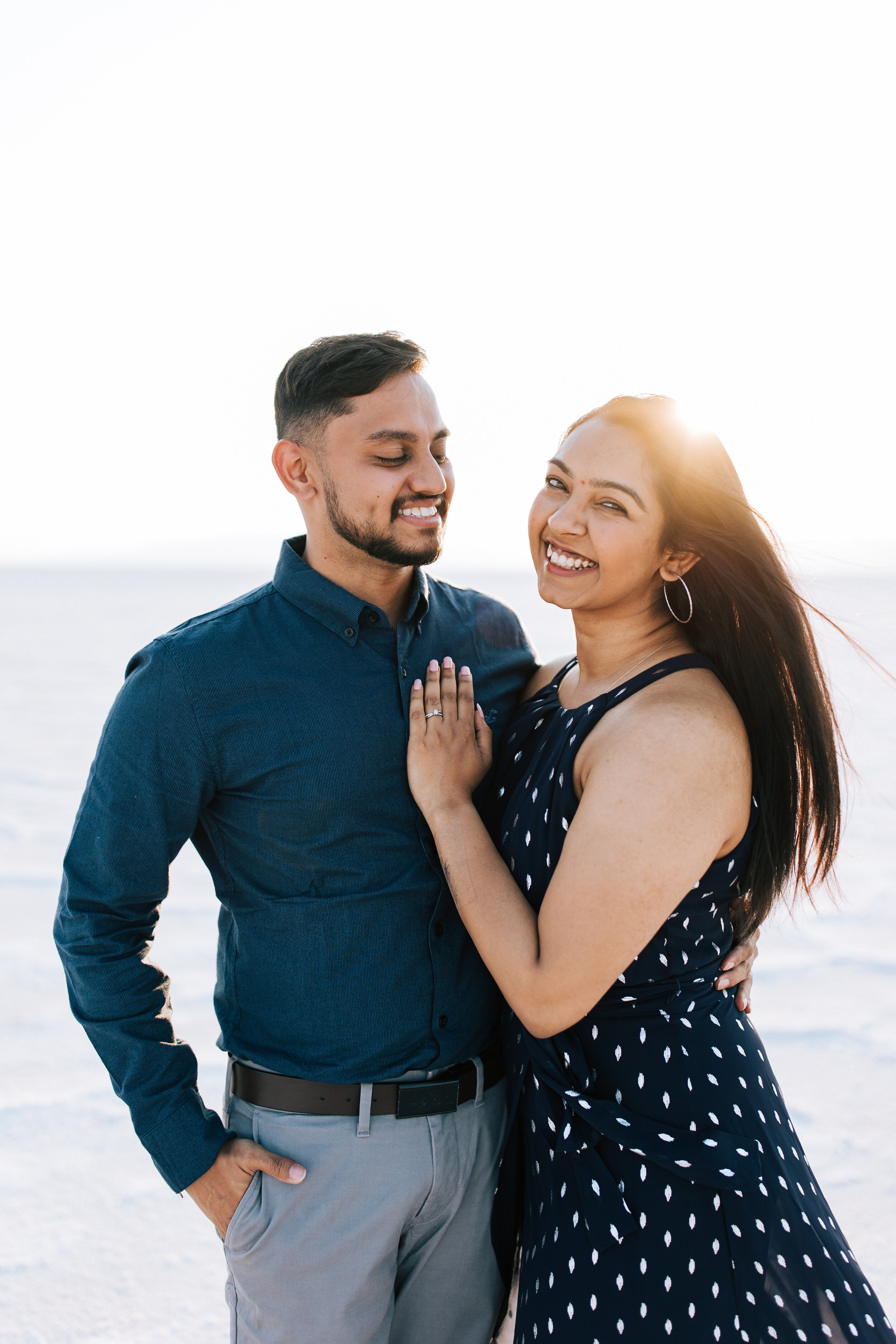  Engagement session at Bonneville Salt Flats near Salt Lake City, Utah. Couple walks across the Salt Flats near Wendover. Summer engagement shoot in Utah. Engagement shoot locations in Utah. Best places for engagement photos in Utah. Engagement outfi