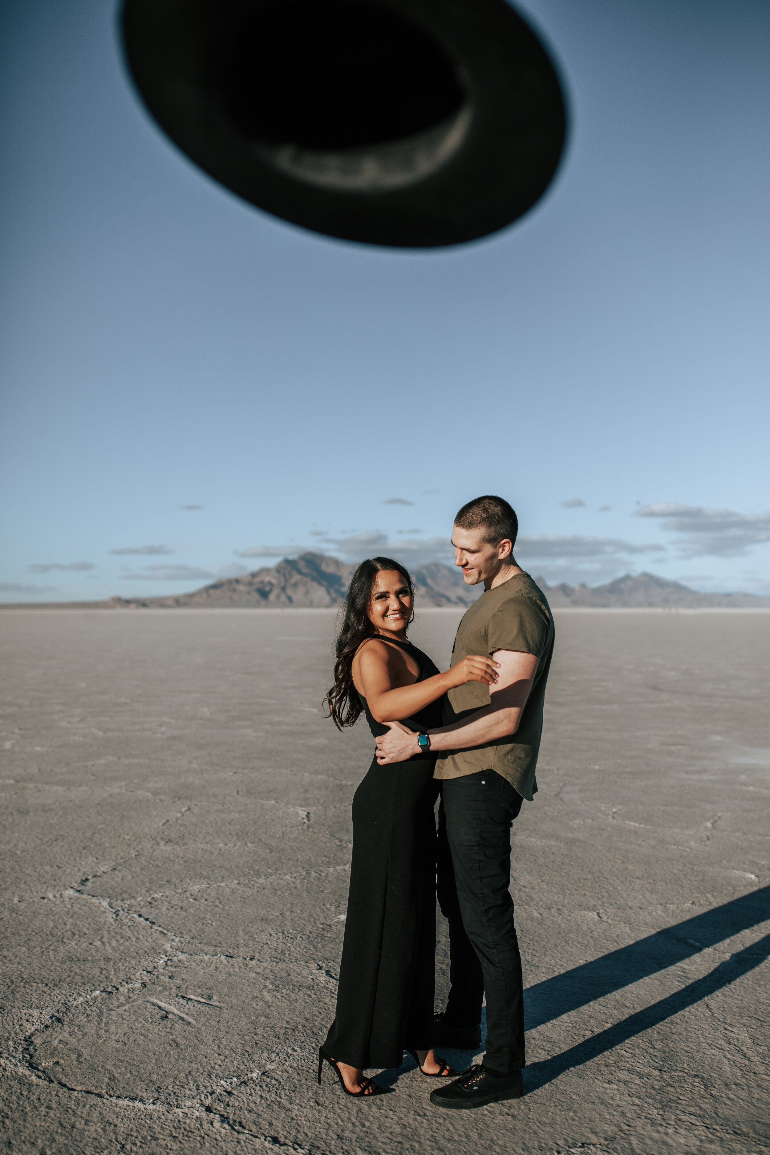  Engagement session at Bonneville Salt Flats near Salt Lake City, Utah. Couple walks across the Salt Flats near Wendover. Summer engagement shoot in Utah. Engagement shoot locations in Utah. Best places for engagement photos in Utah. Engagement outfi