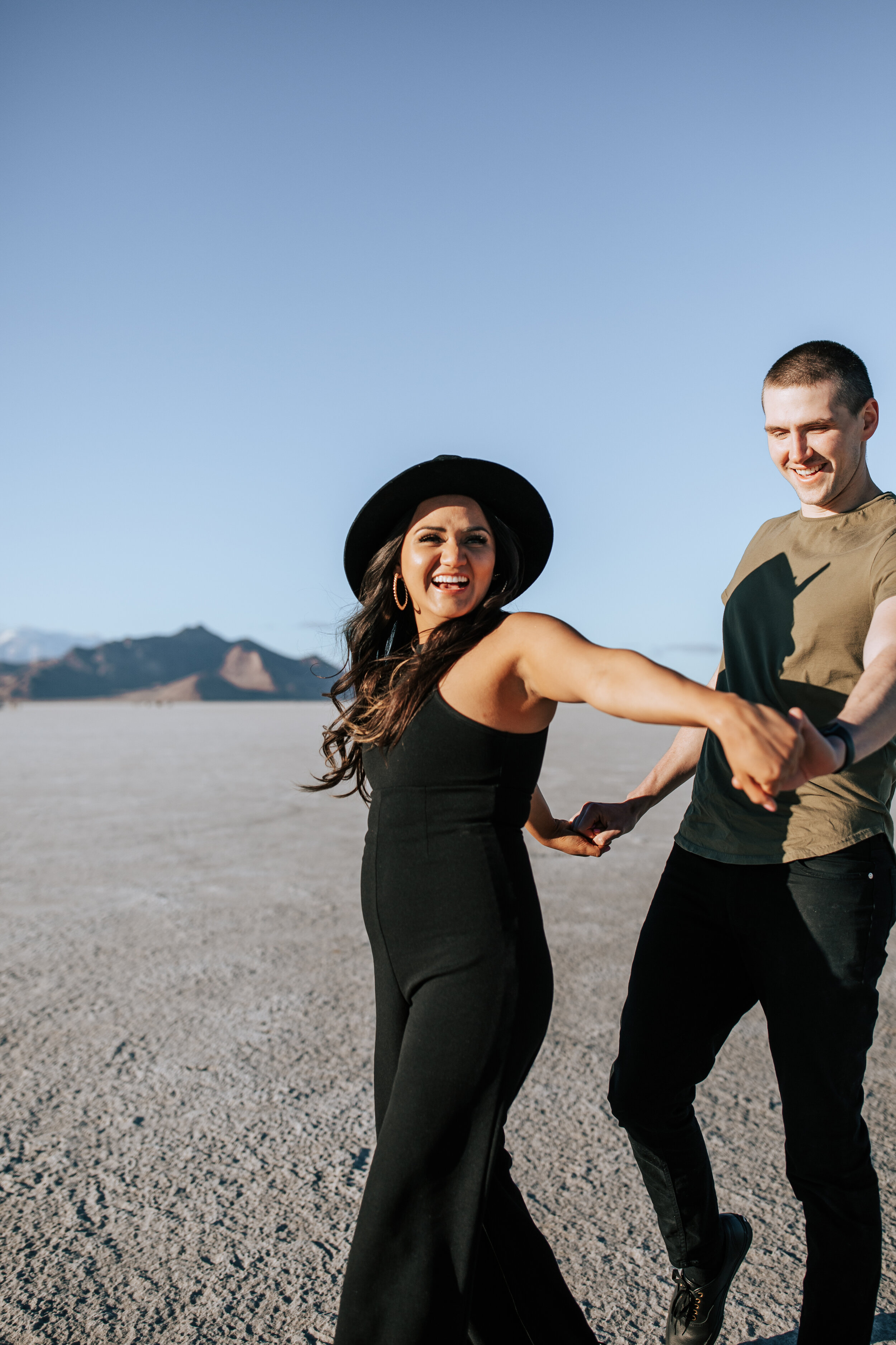  Engagement session at Bonneville Salt Flats near Salt Lake City, Utah. Couple walks across the Salt Flats near Wendover. Summer engagement shoot in Utah. Engagement shoot locations in Utah. Best places for engagement photos in Utah. Engagement outfi