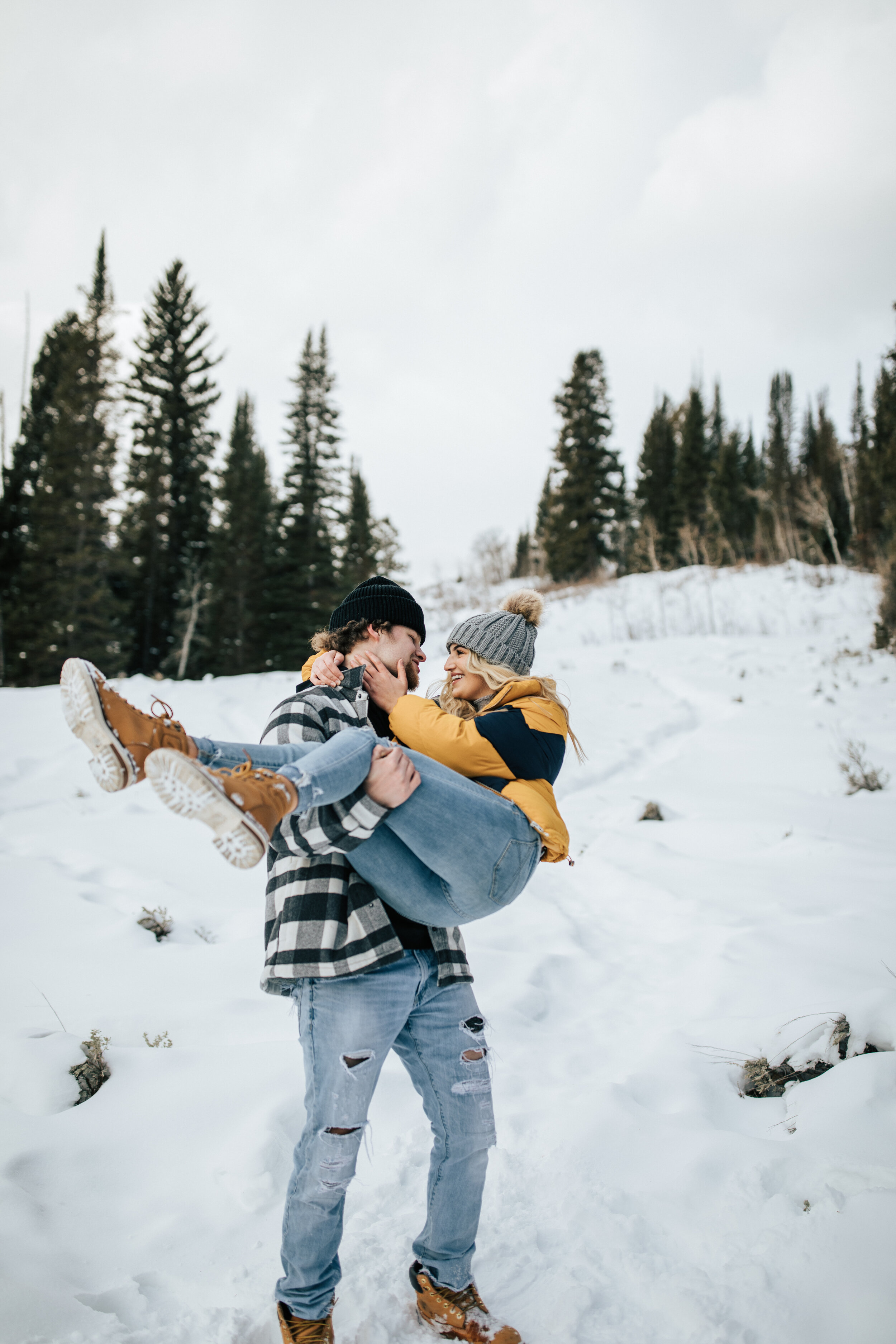  Winter engagement session in Big Cottonwood Canyon at Jordan Pines in the snow. Casual winter outfits with beanies. Utah winter photoshoot locations. Winter couple session in Salt Lake City, Utah. Engagement shoot locations in Utah. Best places for 