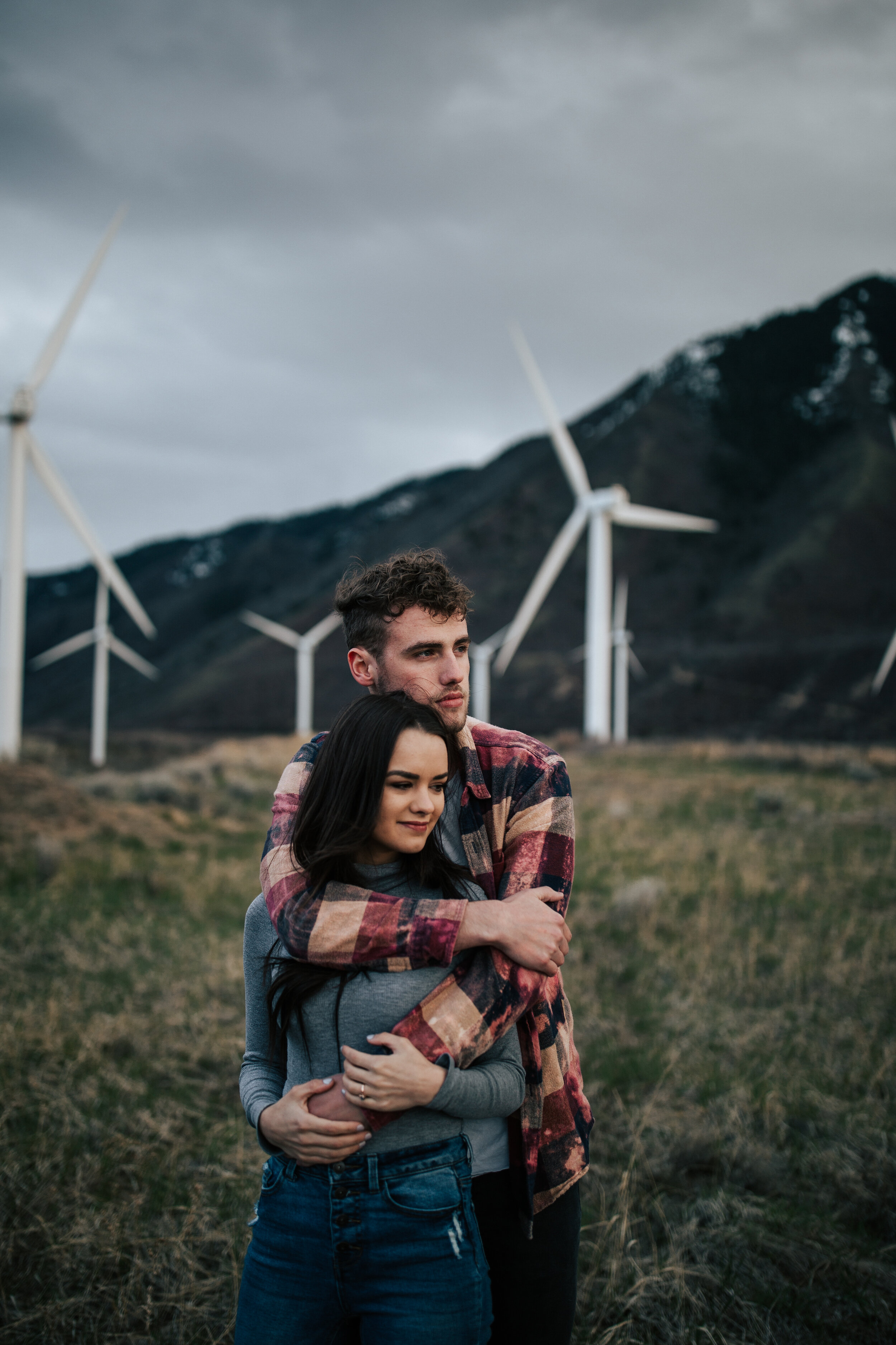  Couples session at the windmills in northern Utah. Moody couples session in the rain. Couple cuddles in the mountains. #weddingphotography #couplesession #engagements 