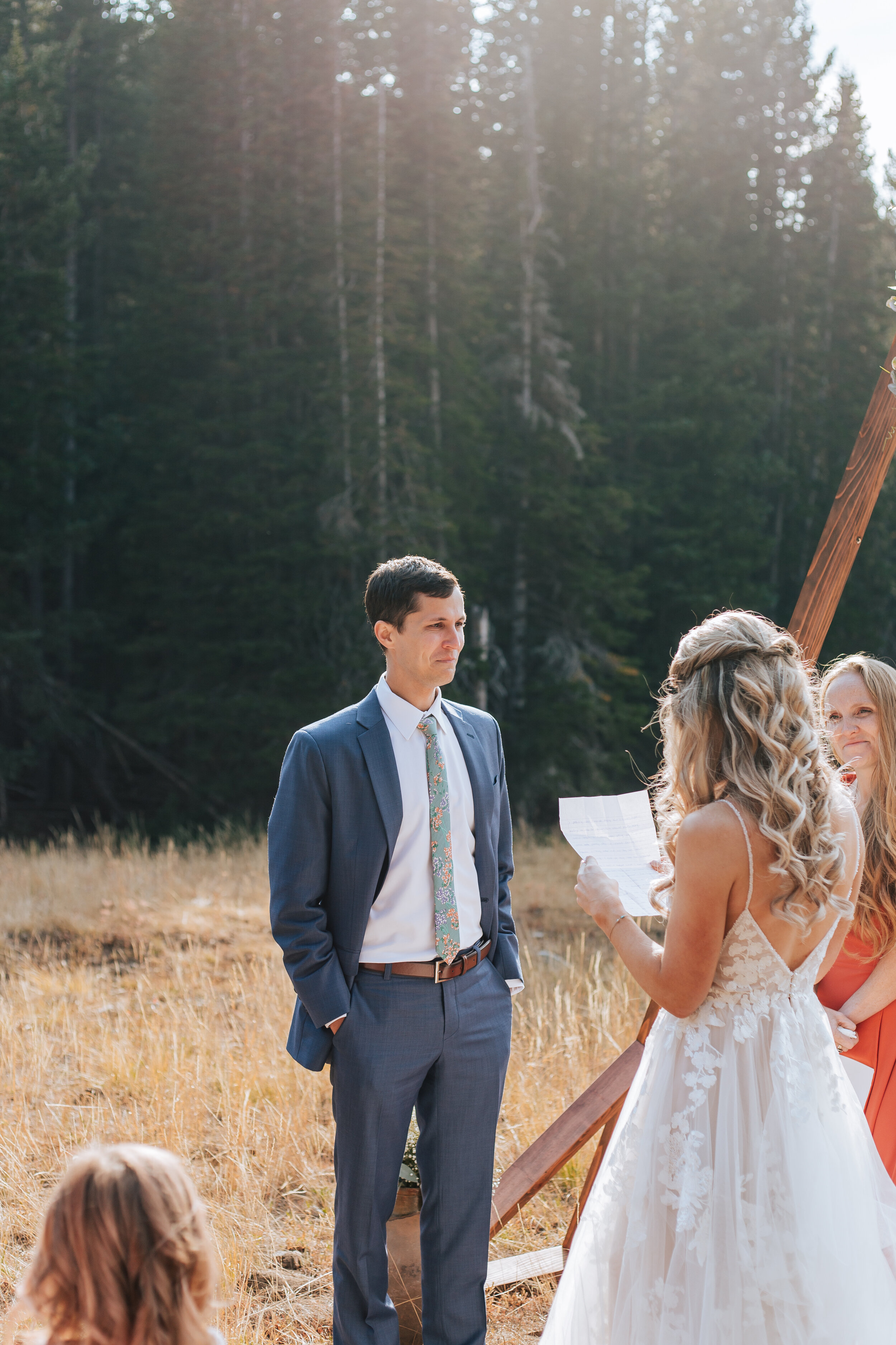  With a beautiful mountain elopement a woman reads her vows to the groom as he tears up by West Coast Elopement Photographer Emily Jenkins Photography. vow photography groom crying mountain wedding locations #emilyjenkinsphotography #emilyjenkinselop