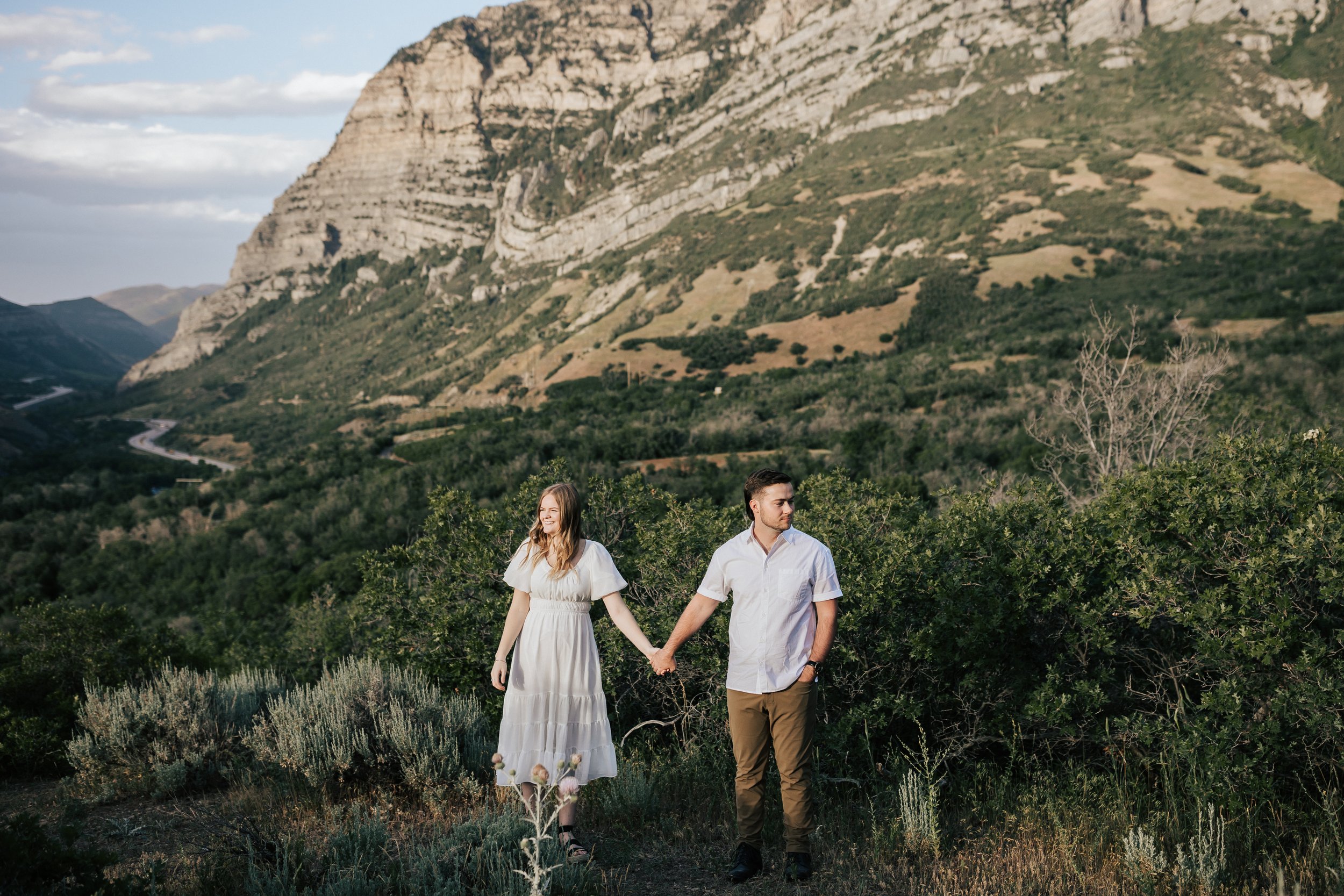  Summer anniversary couples session in the mountains. A young couple stands together in the mountains. Utah photographer. Engagement session. #utahphotographer #utahengagements  