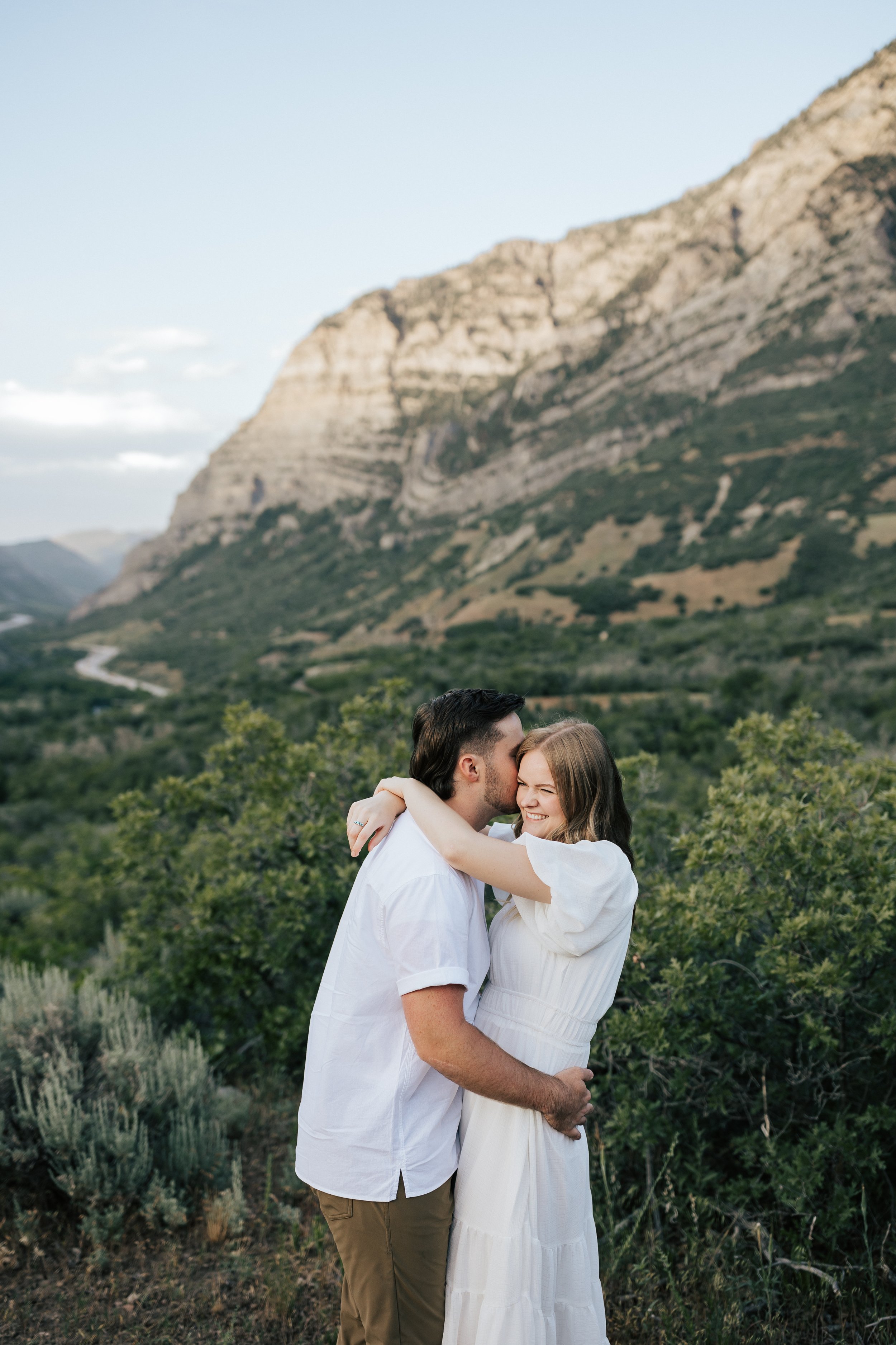  Summer anniversary couples session in the mountains. A young couple cuddles in the mountains. Utah photographer. Engagement session. #utahphotographer #utahengagements  