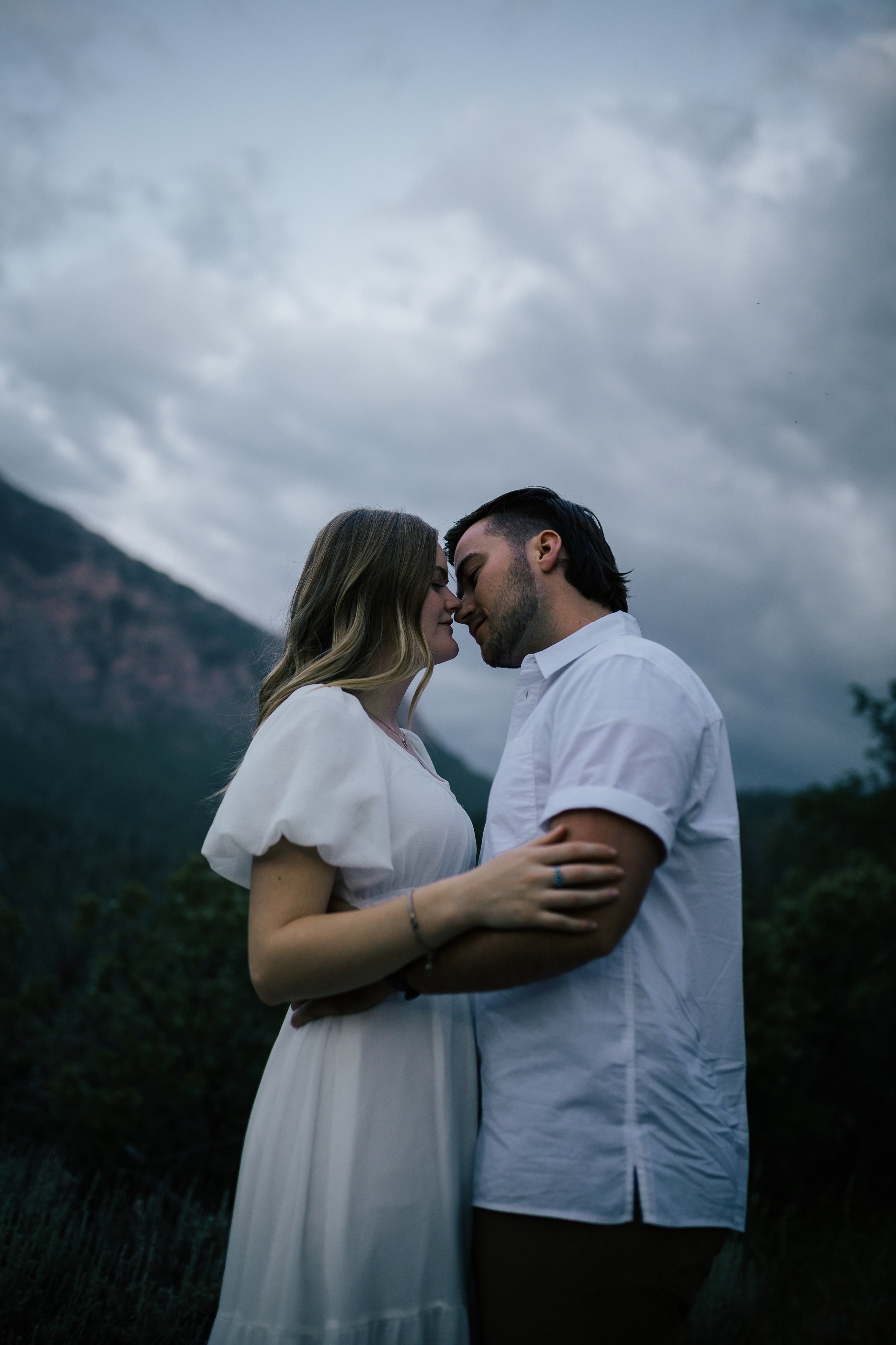  Summer anniversary couples session in the mountains. A young couple walks together as the sun goes down with a colorful pink and blue sky.. Utah photographer. Engagement session. #utahphotographer #utahengagements  