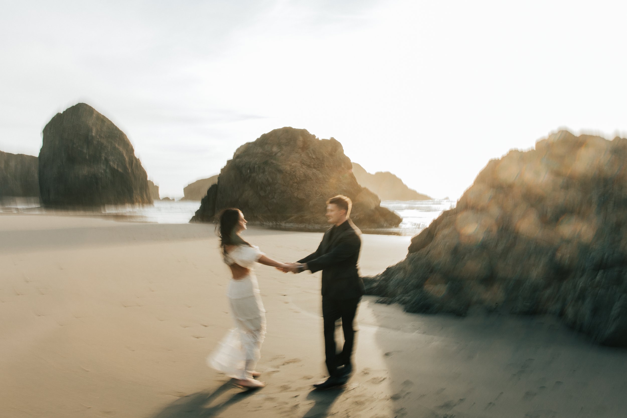  Oregon coast elopement. Couple elopes on the beach with the sun shining behind them. Sun rays behind rocks. Beach with rocks and haystacks. Southern Oregon. Brookings, Oregon. Samuel H Boardman elopement. #oregon #photographer #elopement 
