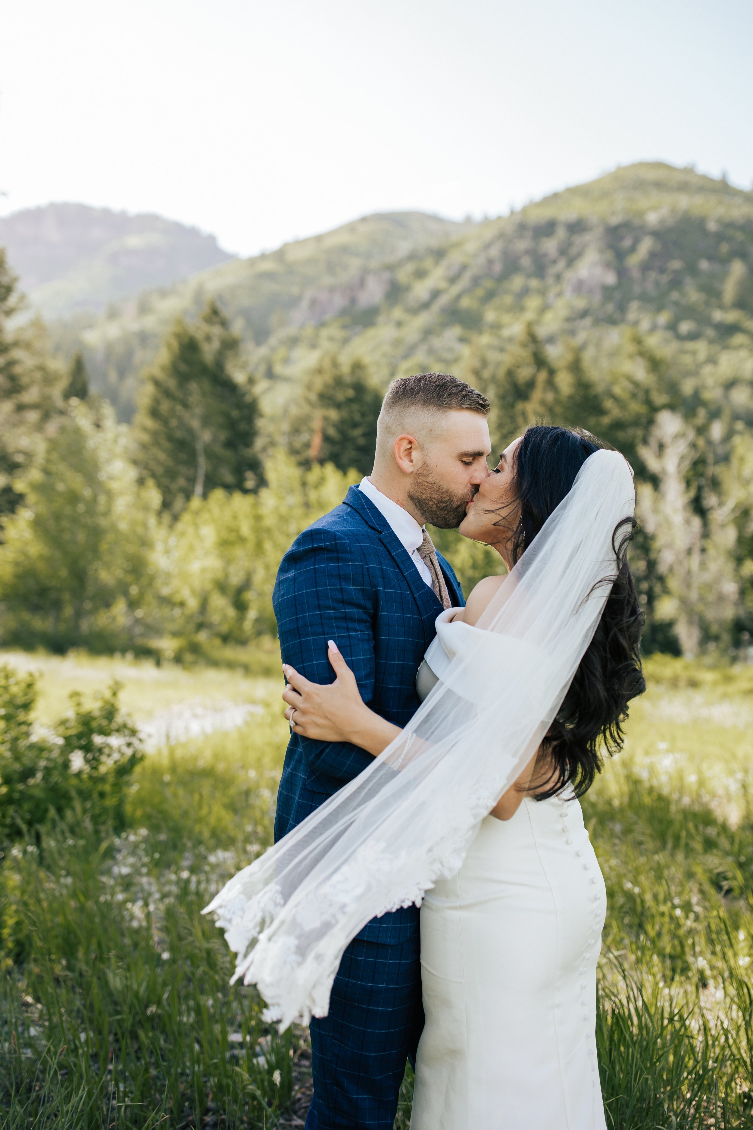  Bride and groom kiss during their look session and bridal session with bride and groom before their wedding ceremony in Aspen Grove, Provo Canyon, Utah. #weddingdress #firstlook #bridalportraits 