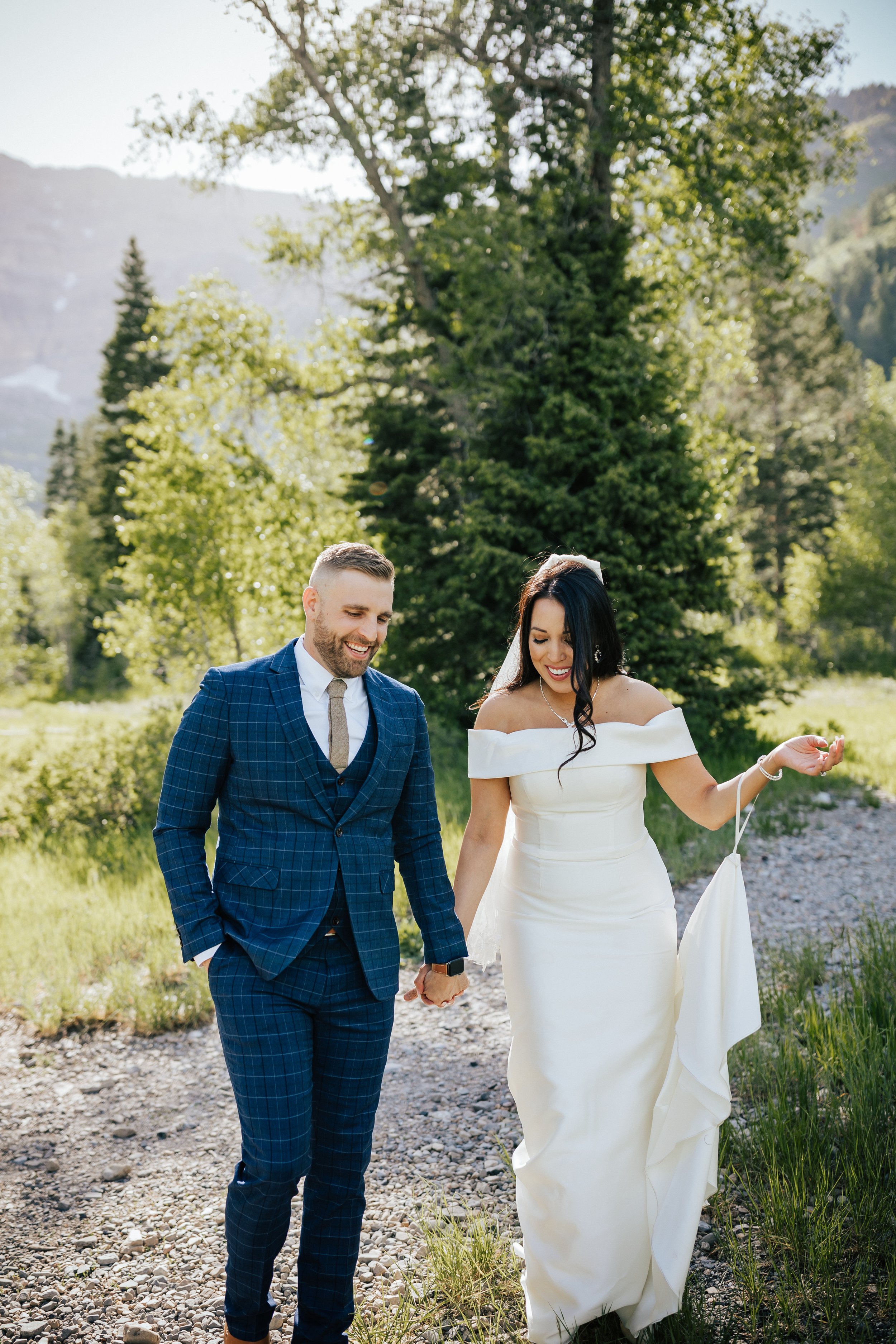  Bride and groom holding hands walking together in the mountains. First look session with bride and groom before their wedding ceremony in Aspen Grove, Provo Canyon, Utah. #weddingdress #firstlook #bridalportraits 