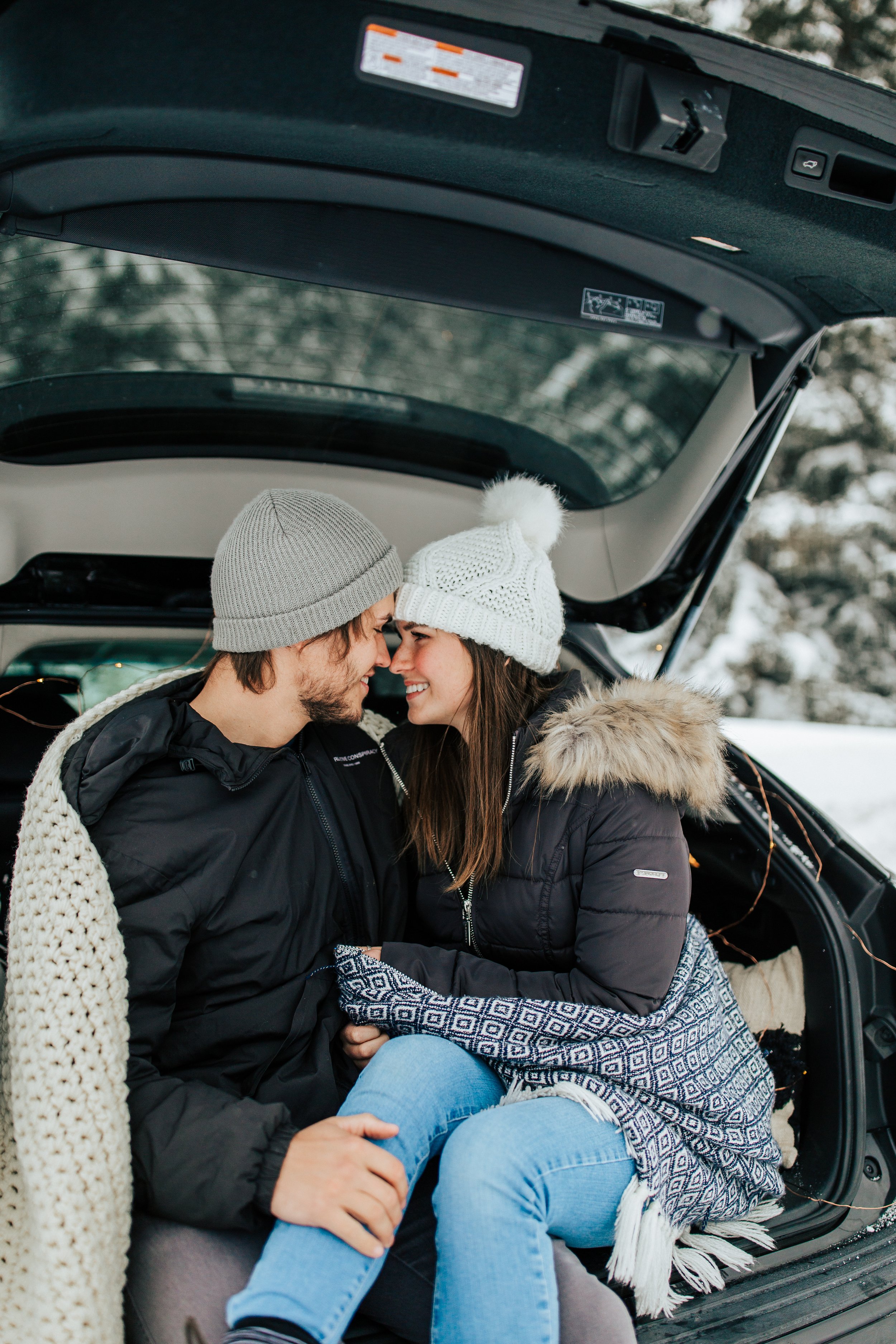  Winter photoshoot outfit inspo. Man and woman kiss in the snowy mountains wearing coats and beanies. Utah mountain engagement shoot in the winter. Salt Lake City, Utah photographer. #winter #engagements #engagementsession #utahphotoshoot #utahengage