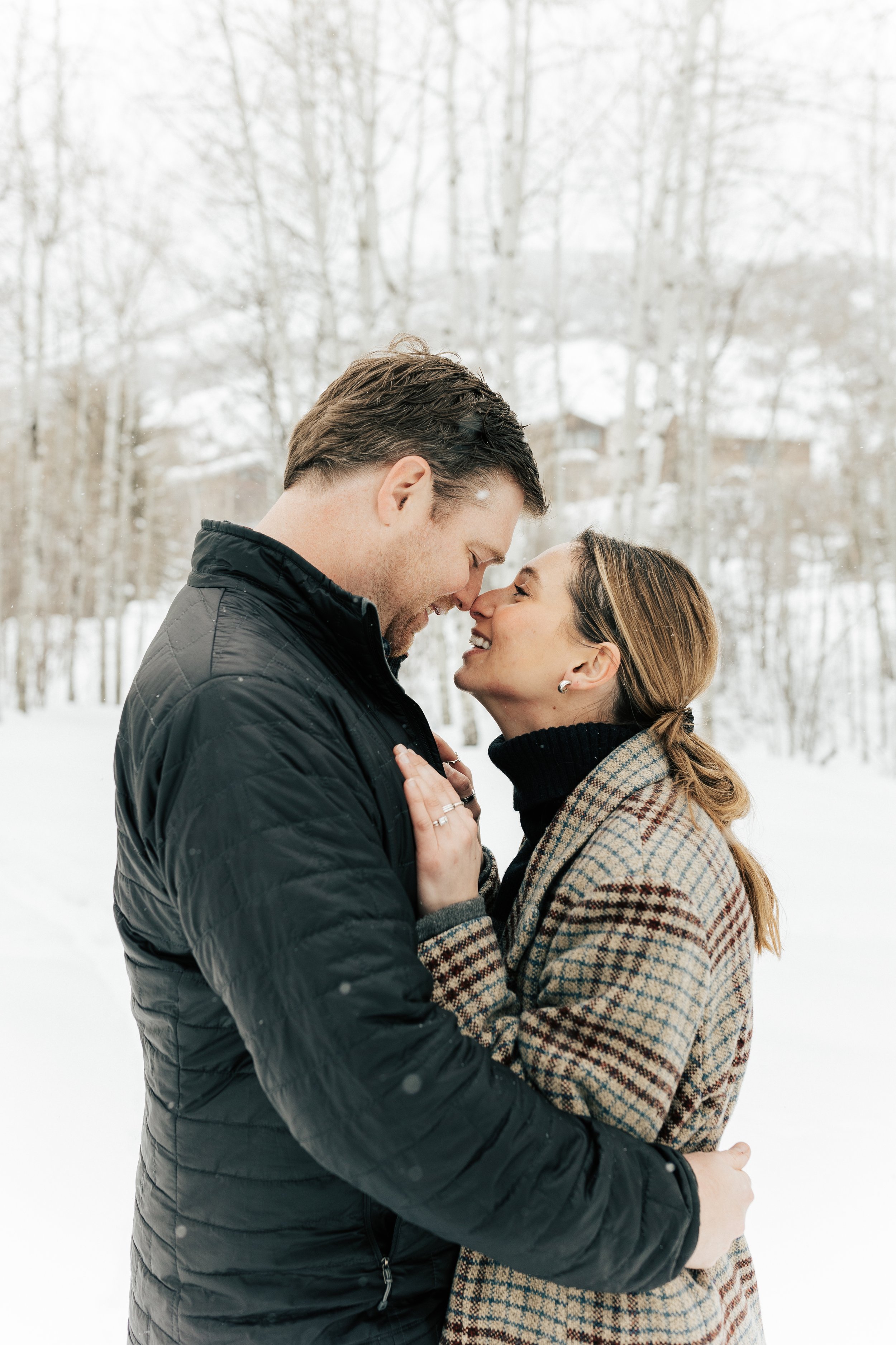  Newly engaged couple kiss. Winter engagement session in Park City, Utah. Boyfriend surprises girlfriend with wedding proposal during a snowy photoshoot. Man proposes to girlfriend. #parkcity #engagements #engagementsessionn #proposal 