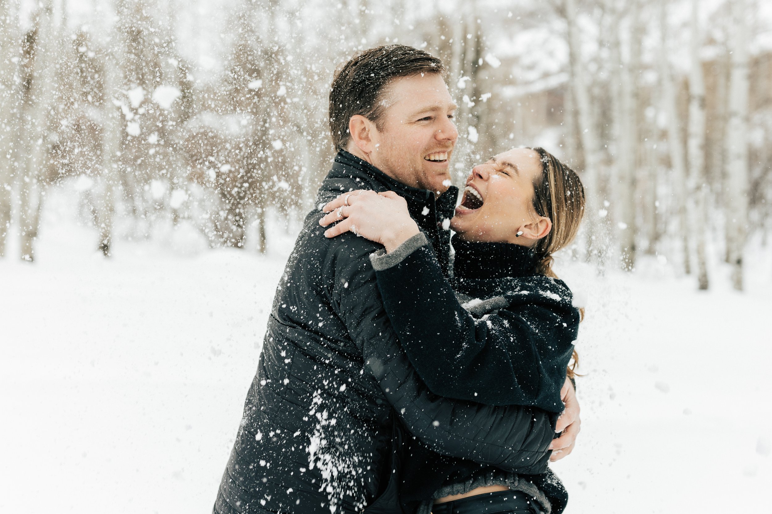  Newly engaged couple snowball fight. Winter engagement session in Park City, Utah. Boyfriend surprises girlfriend with wedding proposal during a snowy photoshoot. Man proposes to girlfriend. #parkcity #engagements #engagementsessionn #proposal 