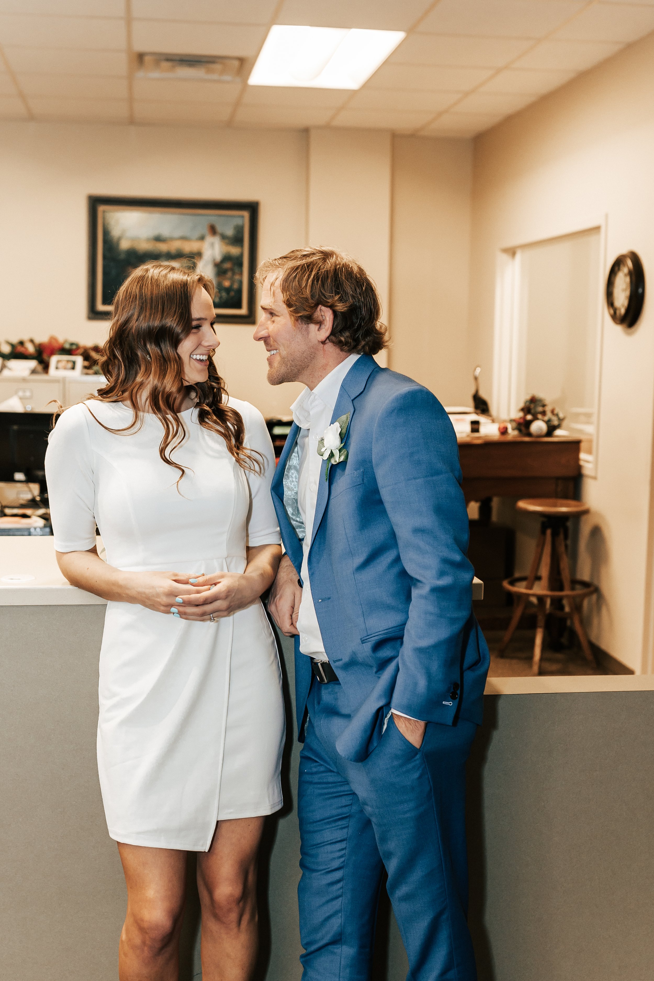  Courthouse elopement for this park city utah couple knee-length white dress short wedding dress for bride elopement style blue suit summit county courthouse elopement in park city in winter wedding Emily Jenkins Photo #elopement #parkcityutah #parkc