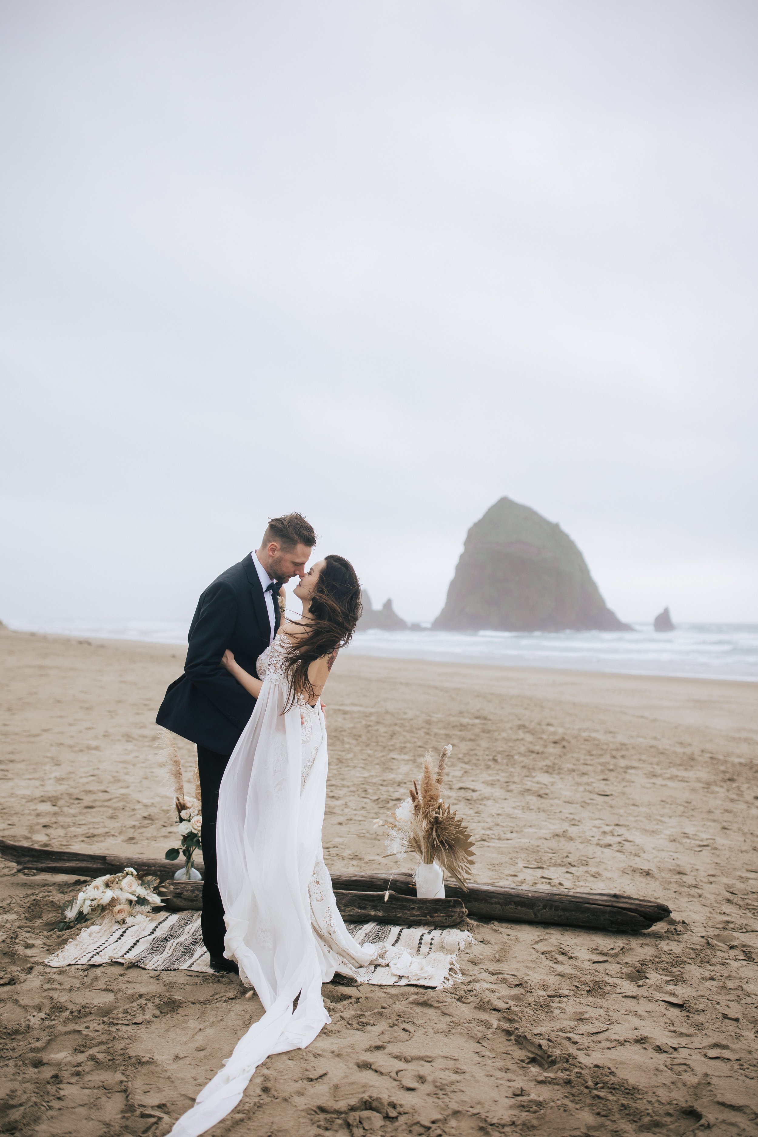  Bride and groom share a kiss oregon elopement learn how to elope to cannon beach in the pacific northwest with stunning wedding photography by emily jenkins photo elopement photographer seaside oregon cannon beach #pnw #pnwwedding #pnwelopement #can