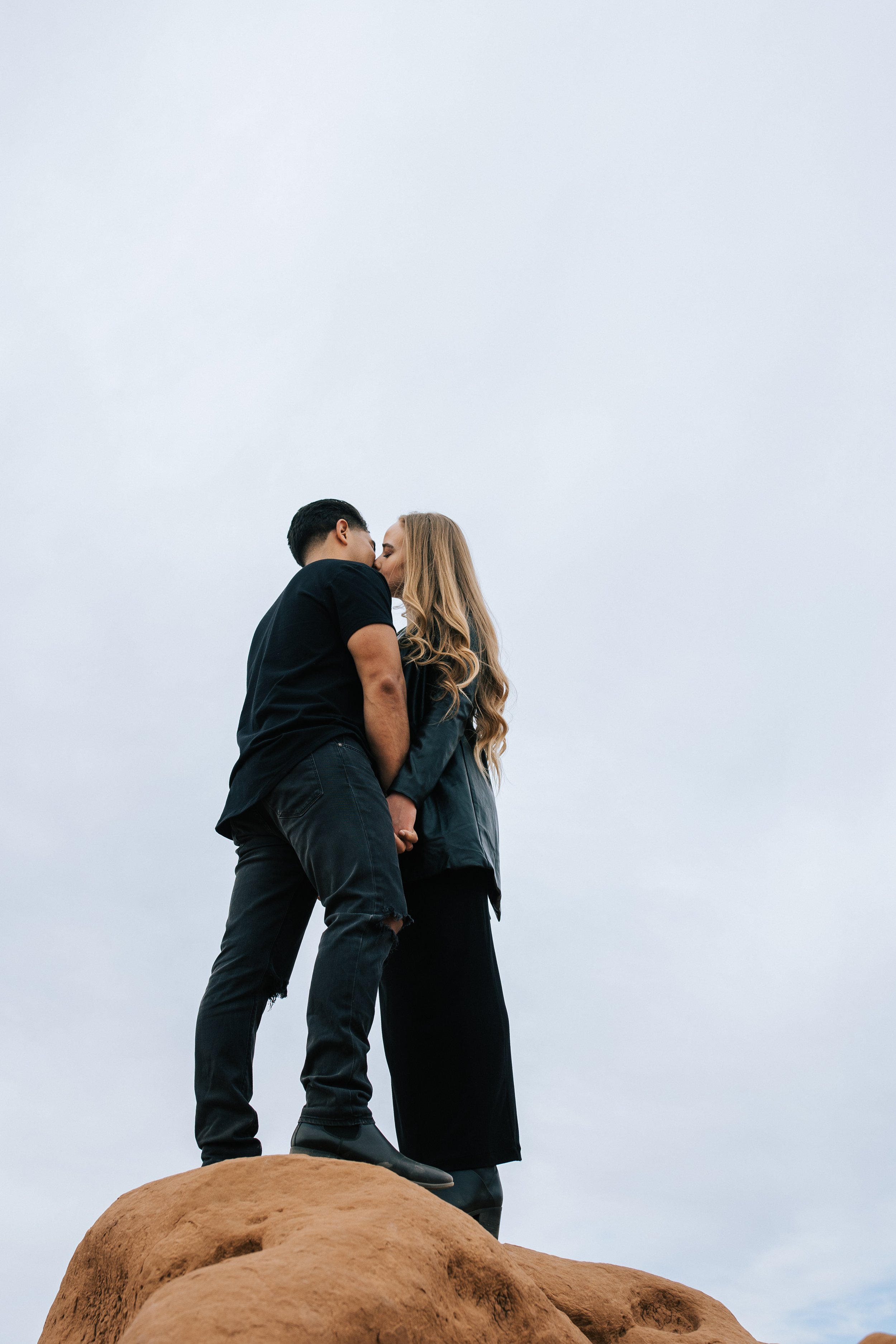  Professional engagement and wedding photographer Emily Jenkins captures a couple standing on a rock kissing in Goblin Valley. Southern Utah red rock engagements bold engagement portraits #EmilyJenkinsPhotography #EmilyJenkinsEngagements #HanksvilleP
