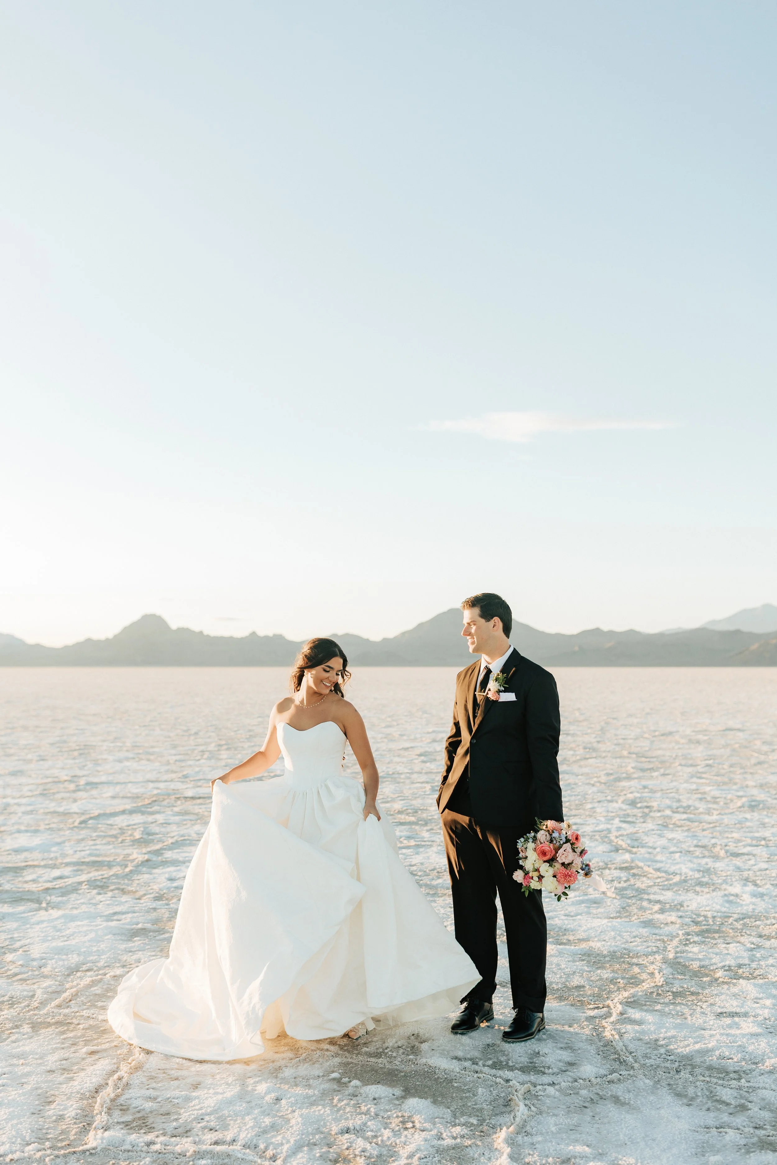  Bride and groom pose for wedding portraits after eloping at the Bonneville Salt Flats in Utah 