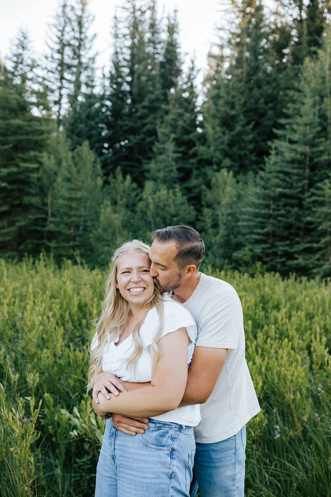 Smiling couple hugging in the mountains