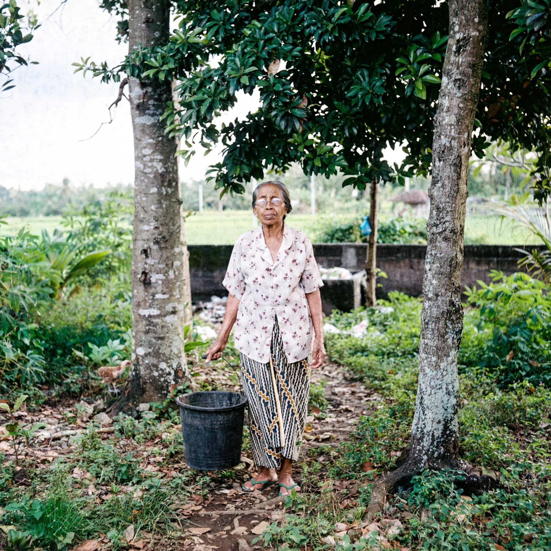 Dadong Topa poses for a portrait at Tunjuk Village, Bali, Indonesia.