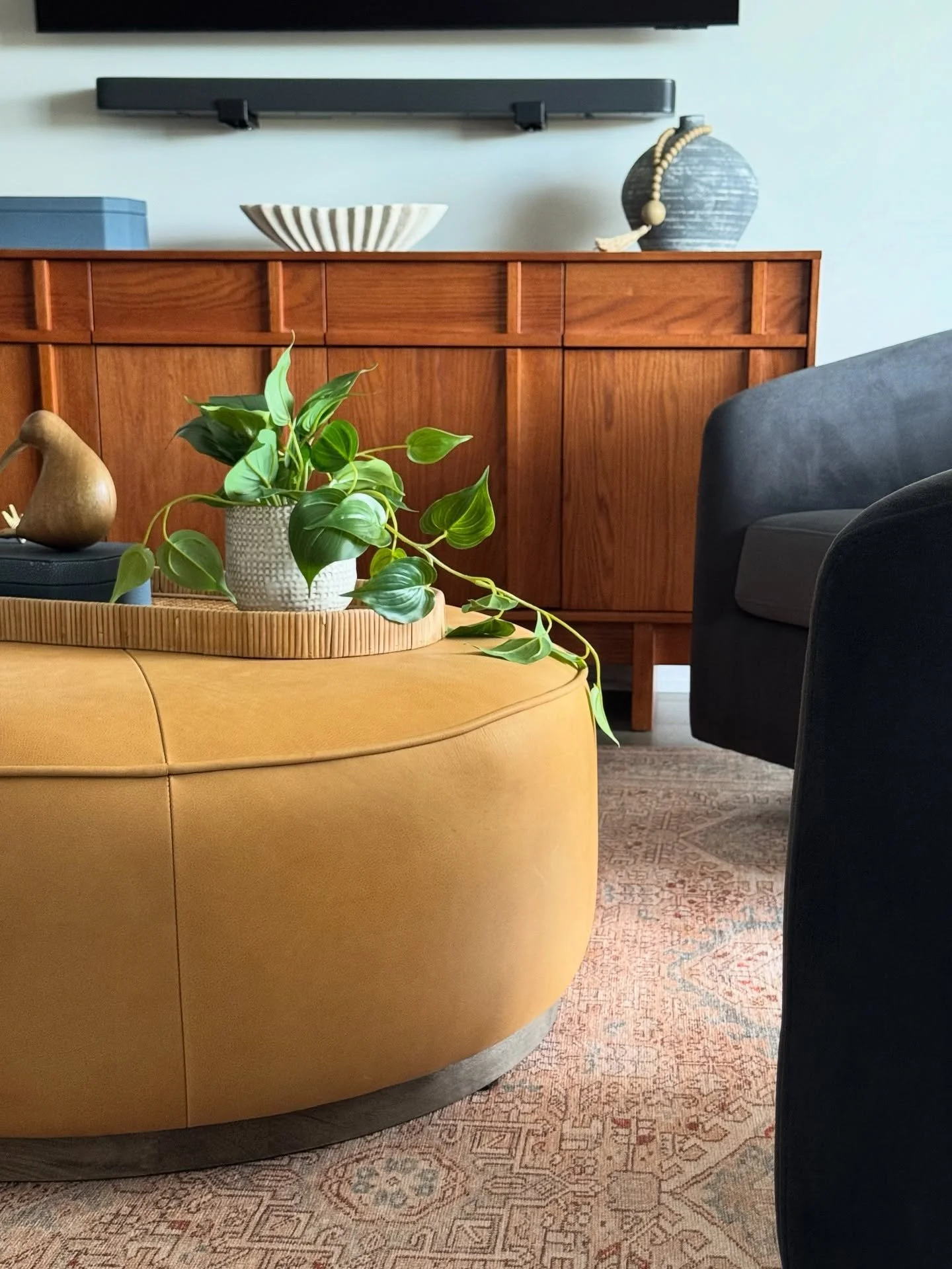 Swivel chairs around a leather ottoman provide a dual purpose - comfortable TV viewing or a nice arrangement for conversation.
