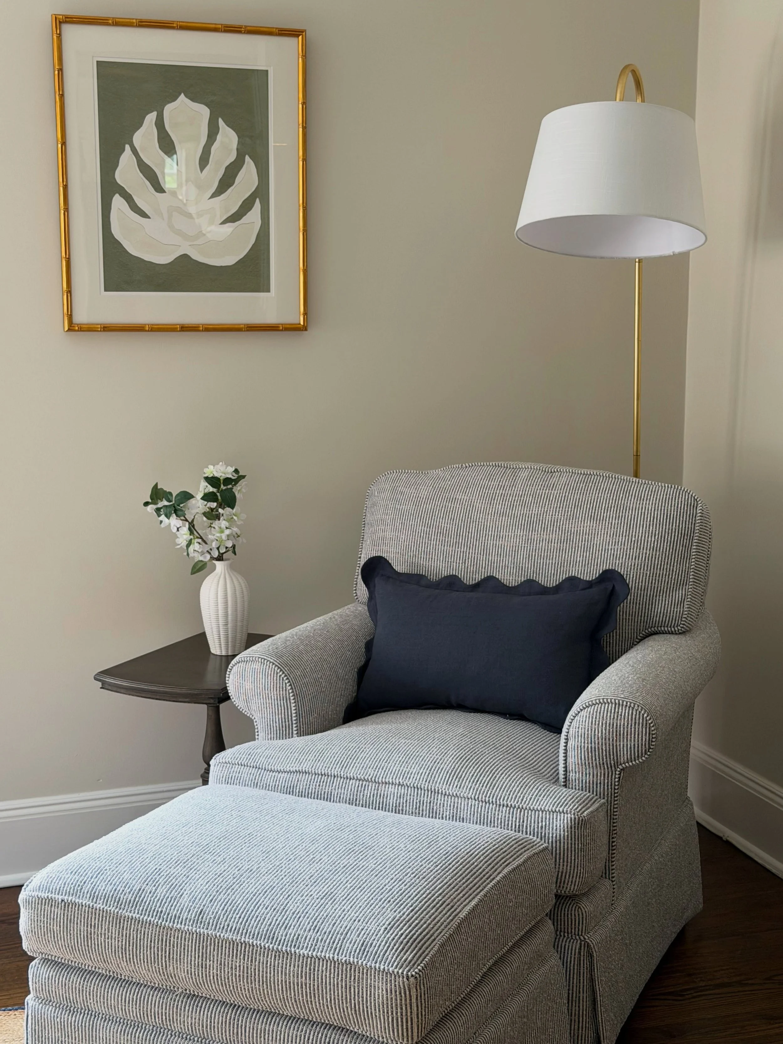 By swapping heavier colors of red and gold to a more calming palette, the room instantly became brighter, lighter, and more inviting for guests. The deep navy accents add just enough contrast while the soft upholstery, tailored bedding, and natural w