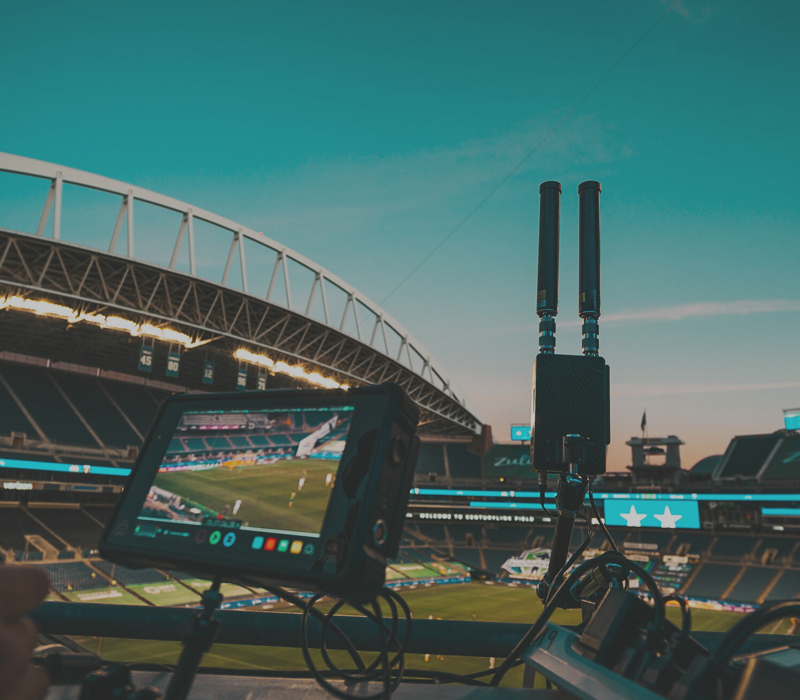 Sports & Entertainment Link over Block Image of Radios and Antennae in a Stadium