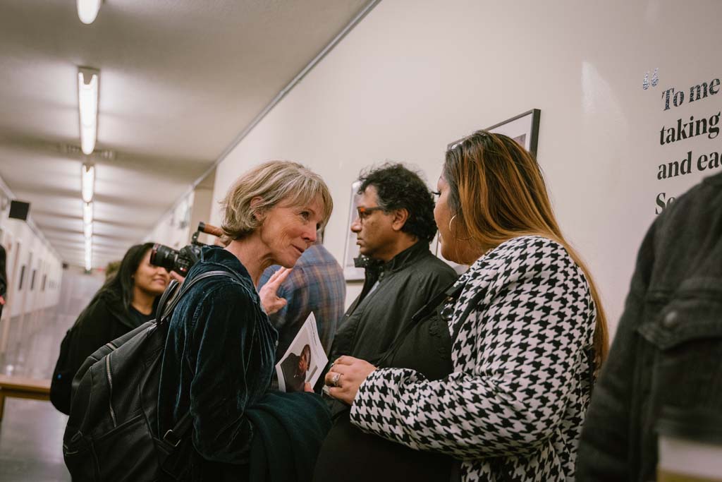 Exhibition visitors discuss the photography in the Visions of Justice showcase at the Hall of Justice. This is the first every visual storytelling event held in this space.