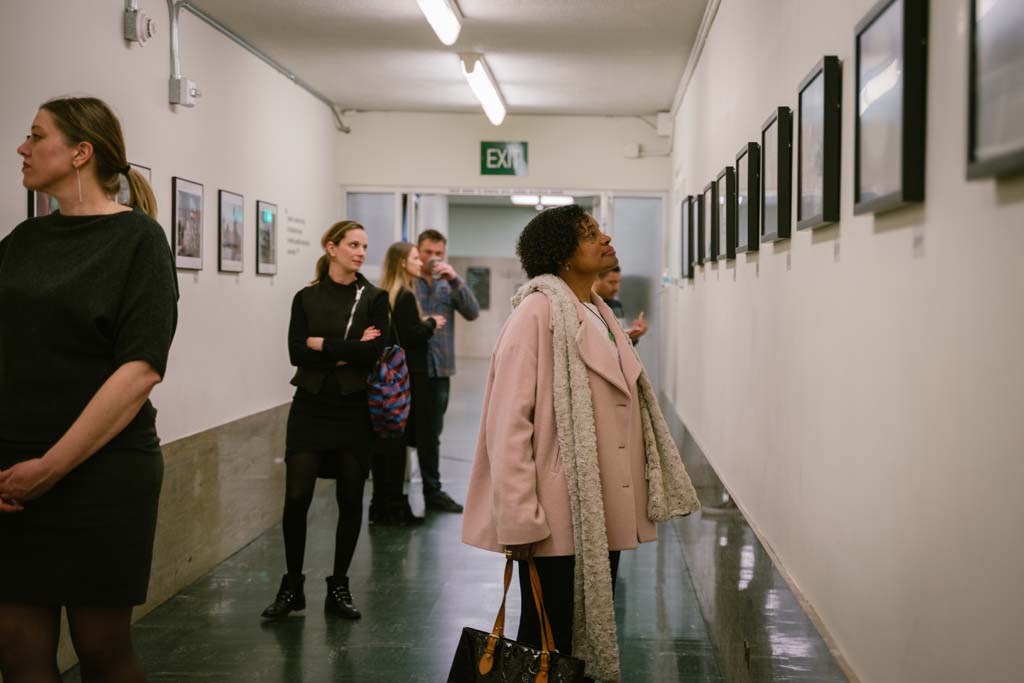 Susan Brown, Director of Special Projects at the Willie Brown Institute, checks out the Visions of Justice exhibition during the opening night.